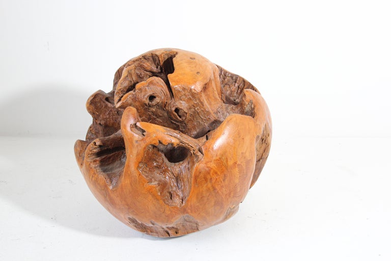 Impressive organic teak wood root shaped into a sphere sculpture.
This large heavy natural teak root sculpture sphere has been hand-carved from reclaimed natural teak wood root sphere to create this perfect beauty sculpture. 
The inner root has