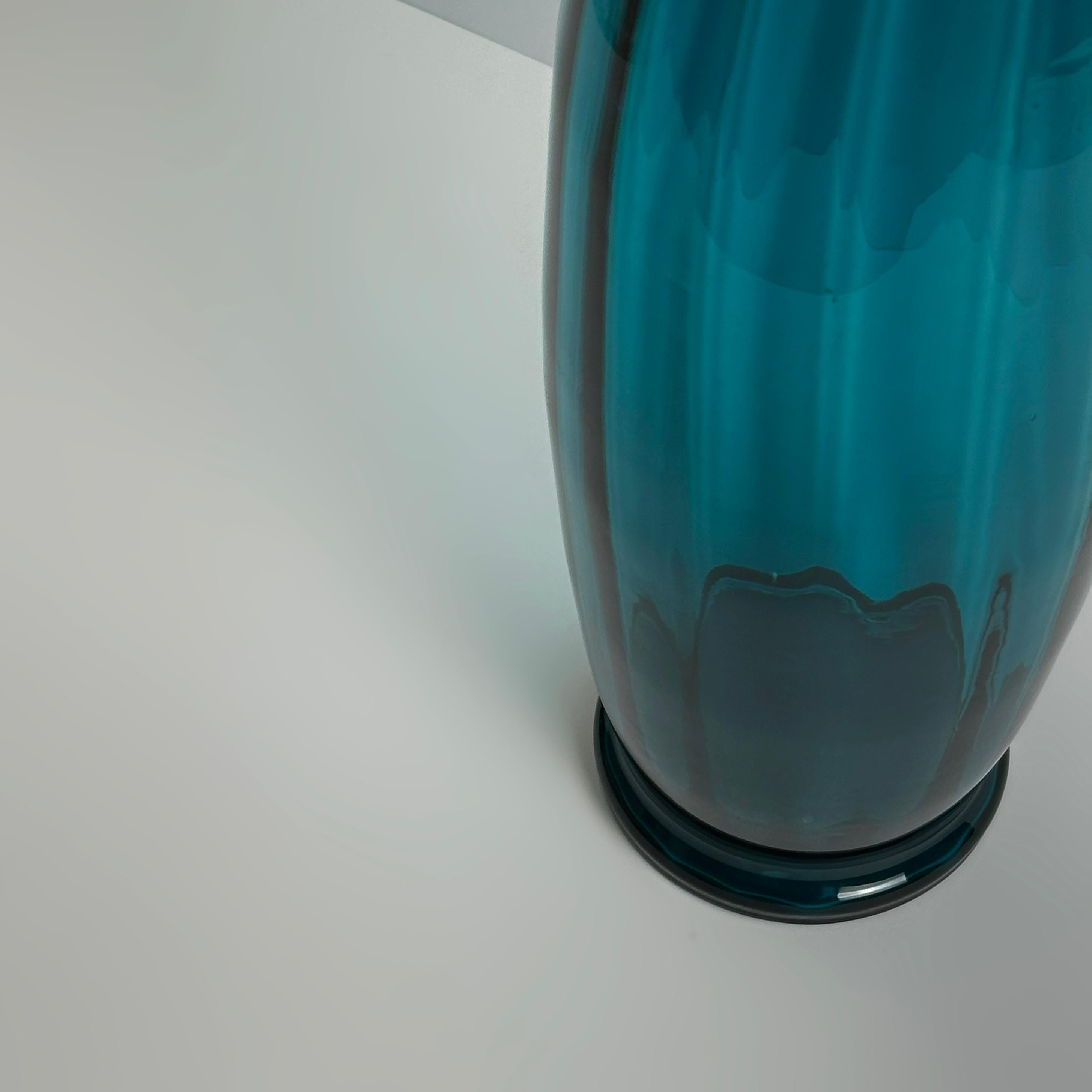 A striking large-scale teal art glass vase, hand-blown in Empoli, Italy, during the 1960s. Attributed to Rossini, a noted maker within the region’s mid-century glass production.

The vase features a tall, gently tapering body that swells at the