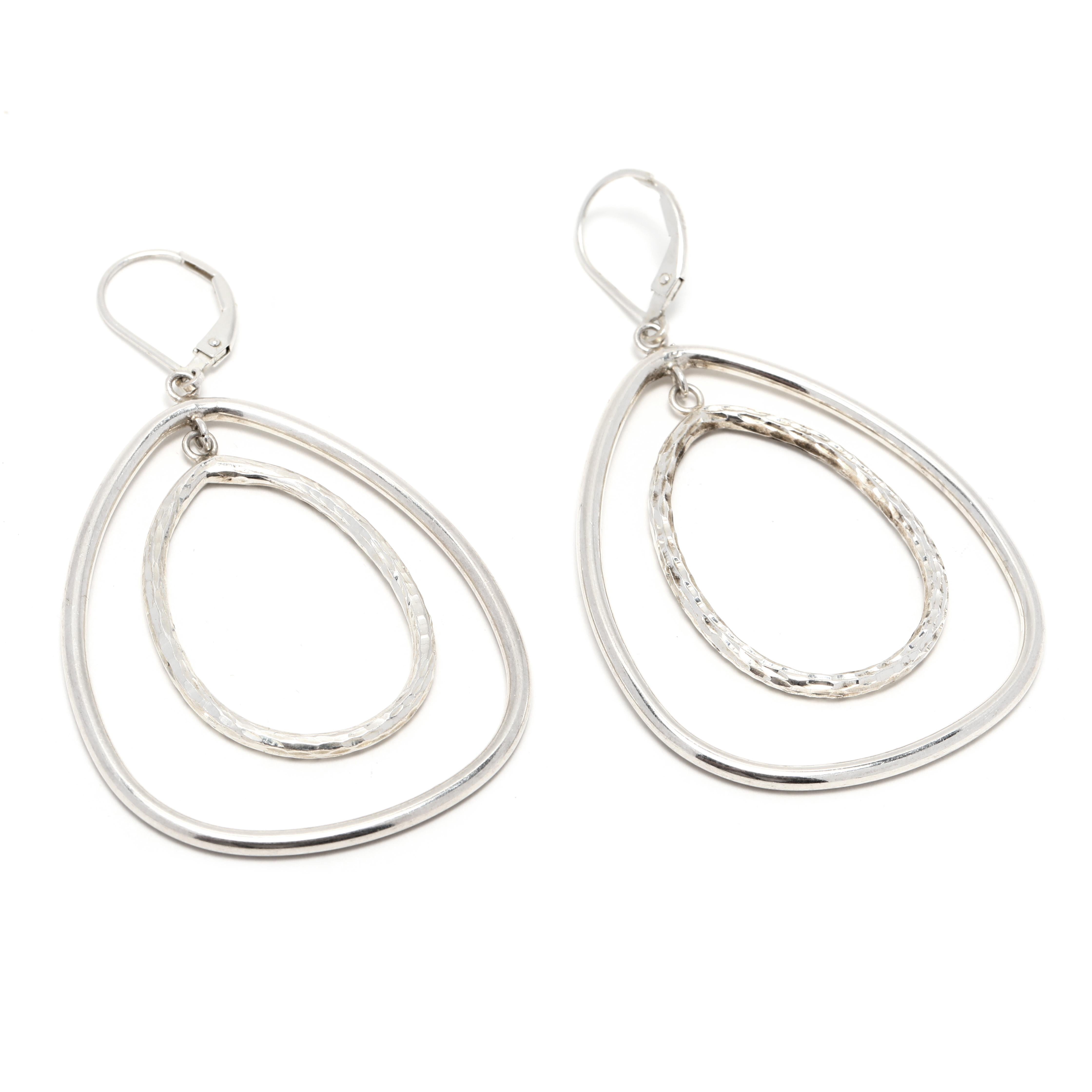 These stunning open teardrop dangle earrings are handcrafted in sterling silver for a light and comfortable fit. At 2 3/8 inch, these earrings are perfect for everyday wear. The polished silver finish will add a touch of elegance to any outfit.