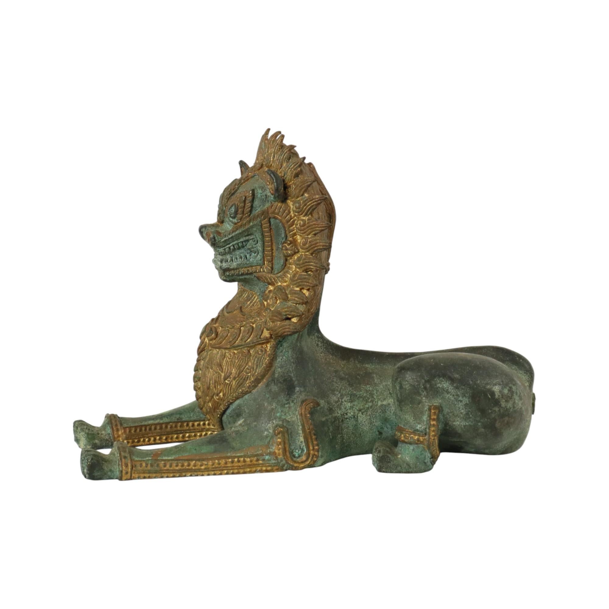Heavy and very nice quality statue of an imperial temple lion, or Singha or foo dog, partly gilded bronze, partly green patinated, Thailand or Cambodia, circa mid 20th century or later.

This sturdy statue is a real eye-catcher, the mane and neck
