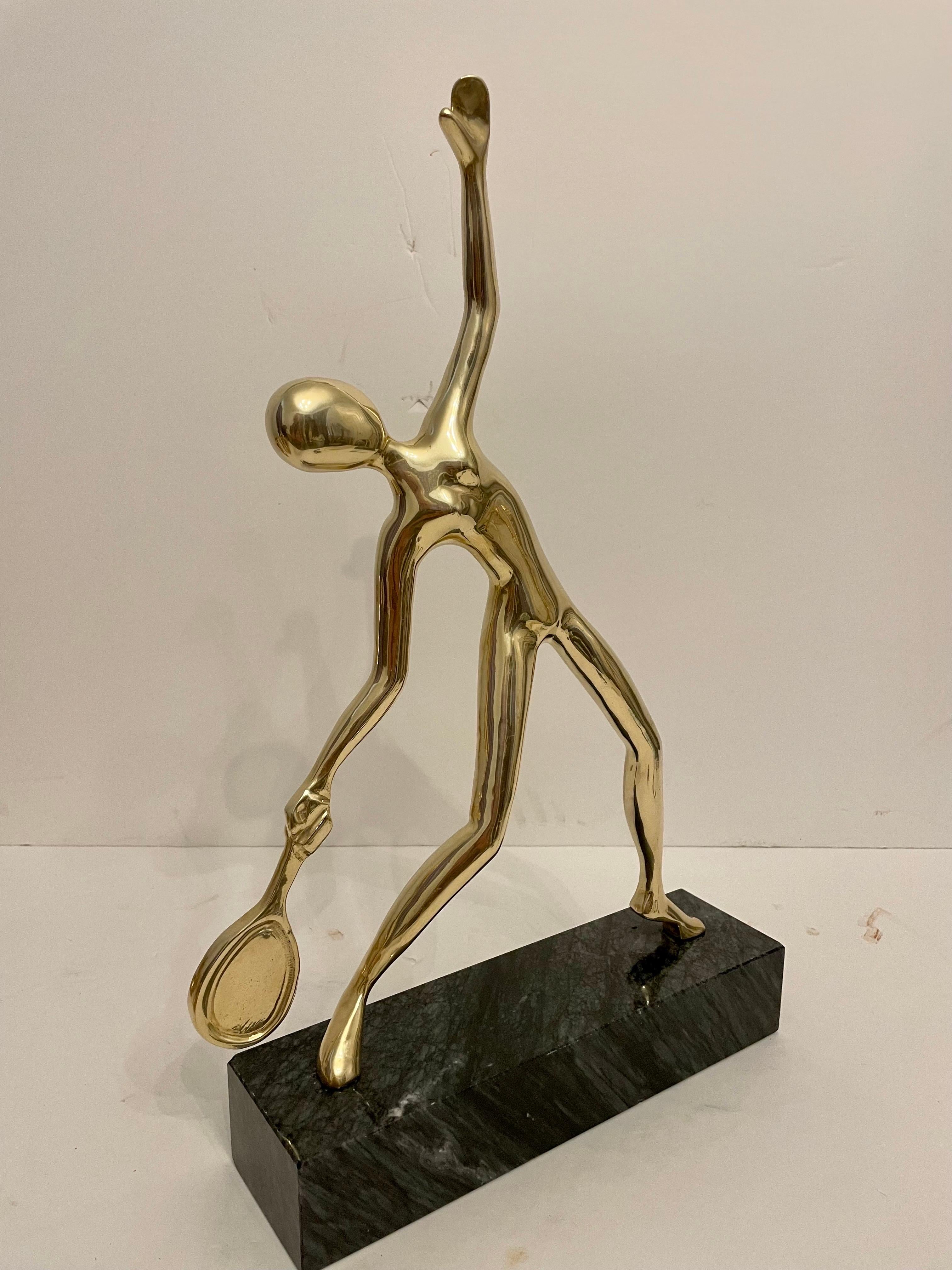 Very unique large heavy solid brass tennis sculpture or statue on grey and black marble base. Great abstract Mid Century form in very good condition. Measures 17