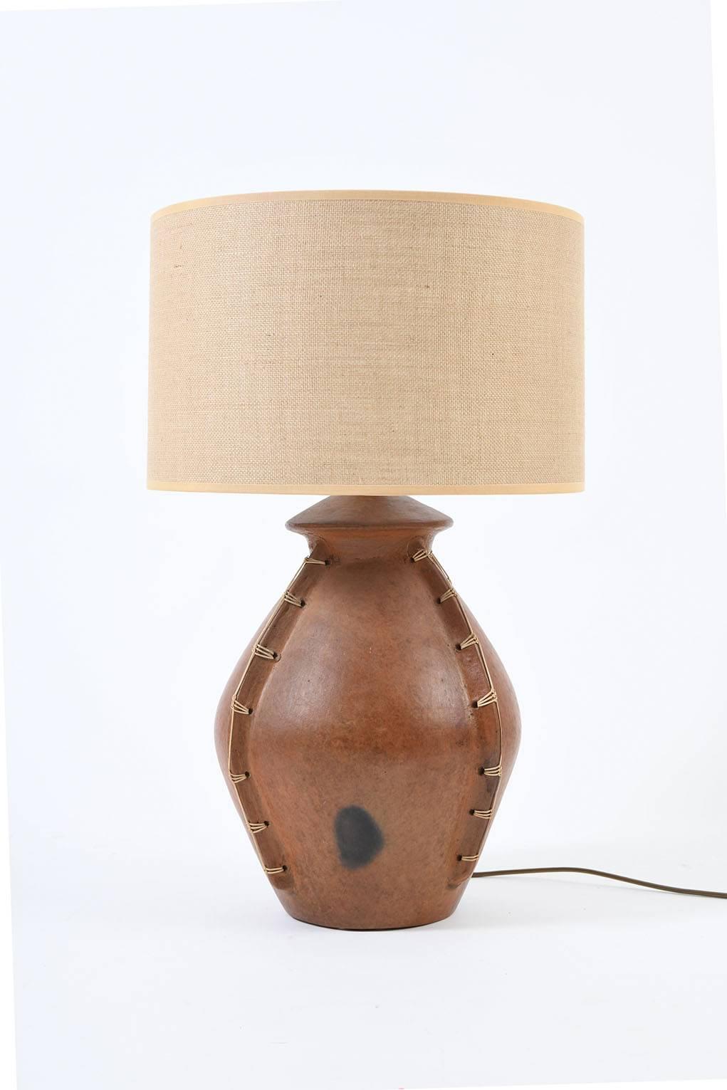 A large terracotta and rattan table lamp
African, for the European market, circa 1950.