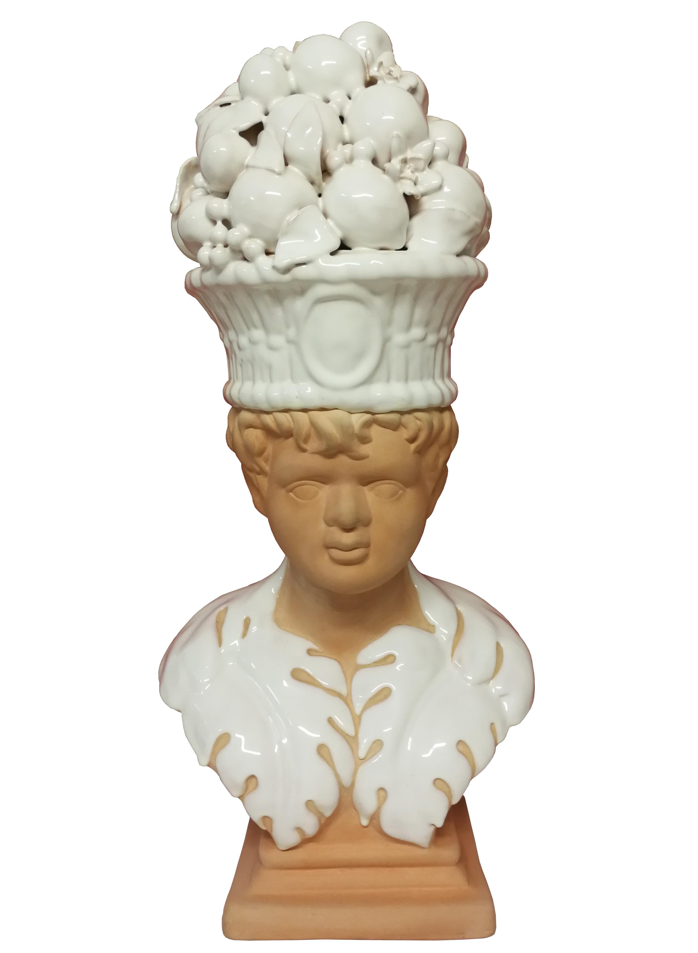 Beautiful and delicate terracota of a child carrying a white glazed fruit basket on his head and white glazed clothing In the Art Nouveau style. 
Spain or Italy 
Circa 1950.
 