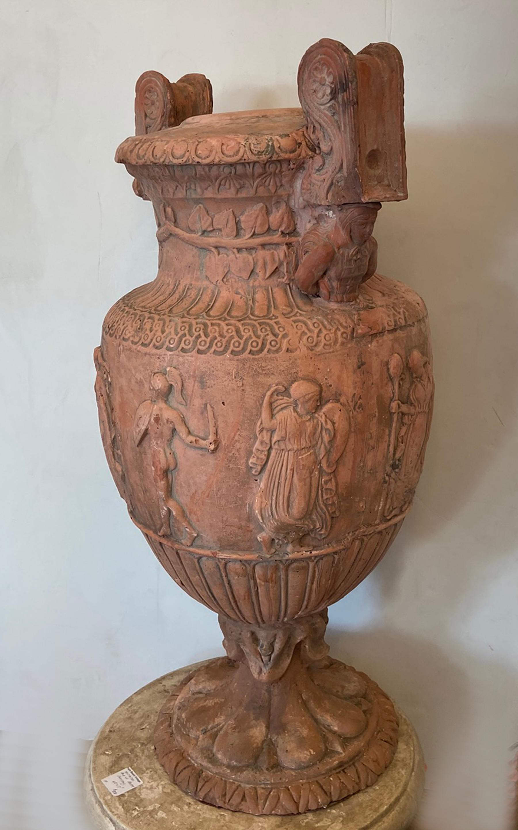 Monumental pair of Blanc terra cotta urns. Large decorative urns with classical figures encircling the vessels. Old red terracotta finish. 16 D by 17 W by 28.5 inches high