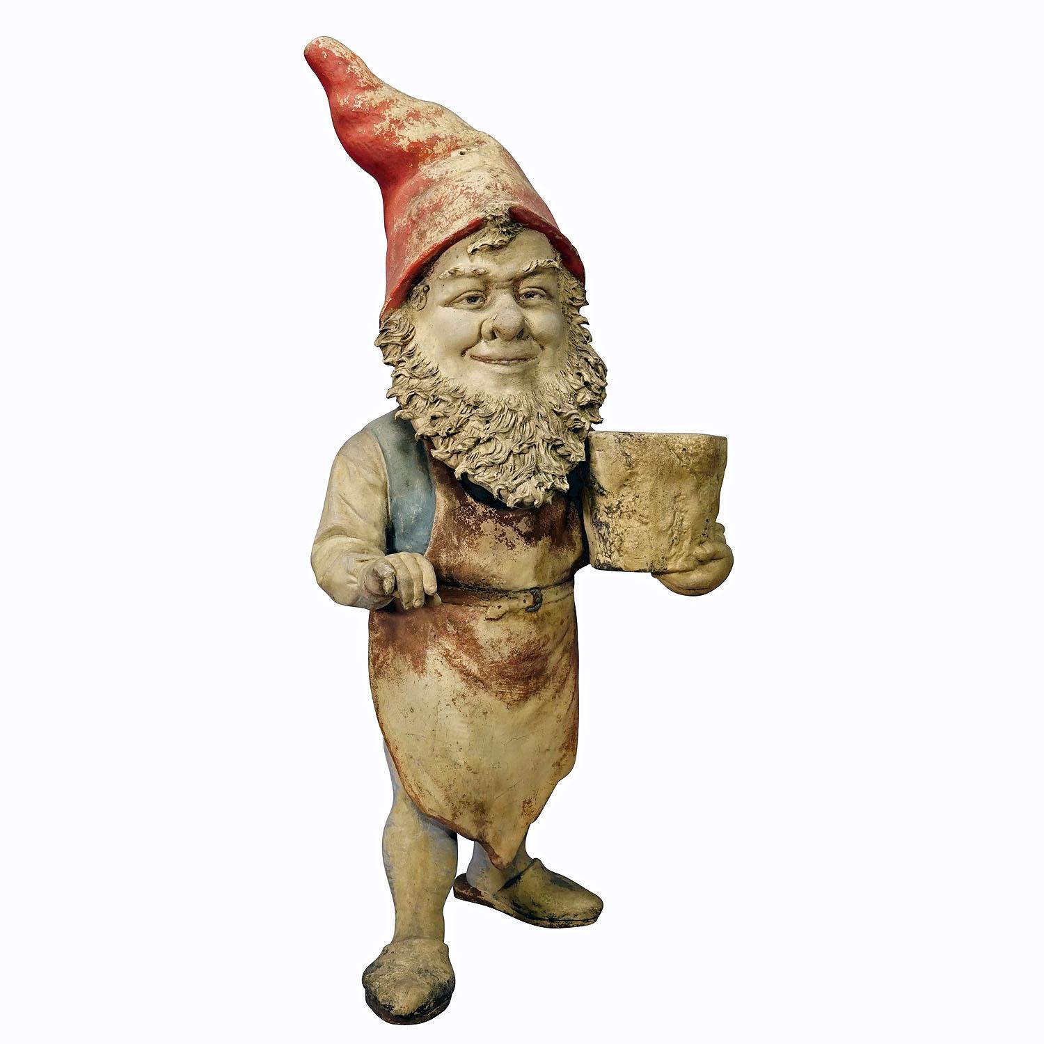 Large Terracotta Garden Gnome with Flower Pot, Germany ca. 1920s

A large garden gnome from Germany, ca. 1920s. The gnome holds a flower pot. Good used antique condition with signs of wear commensurate with age. Some rubbed areas and partially