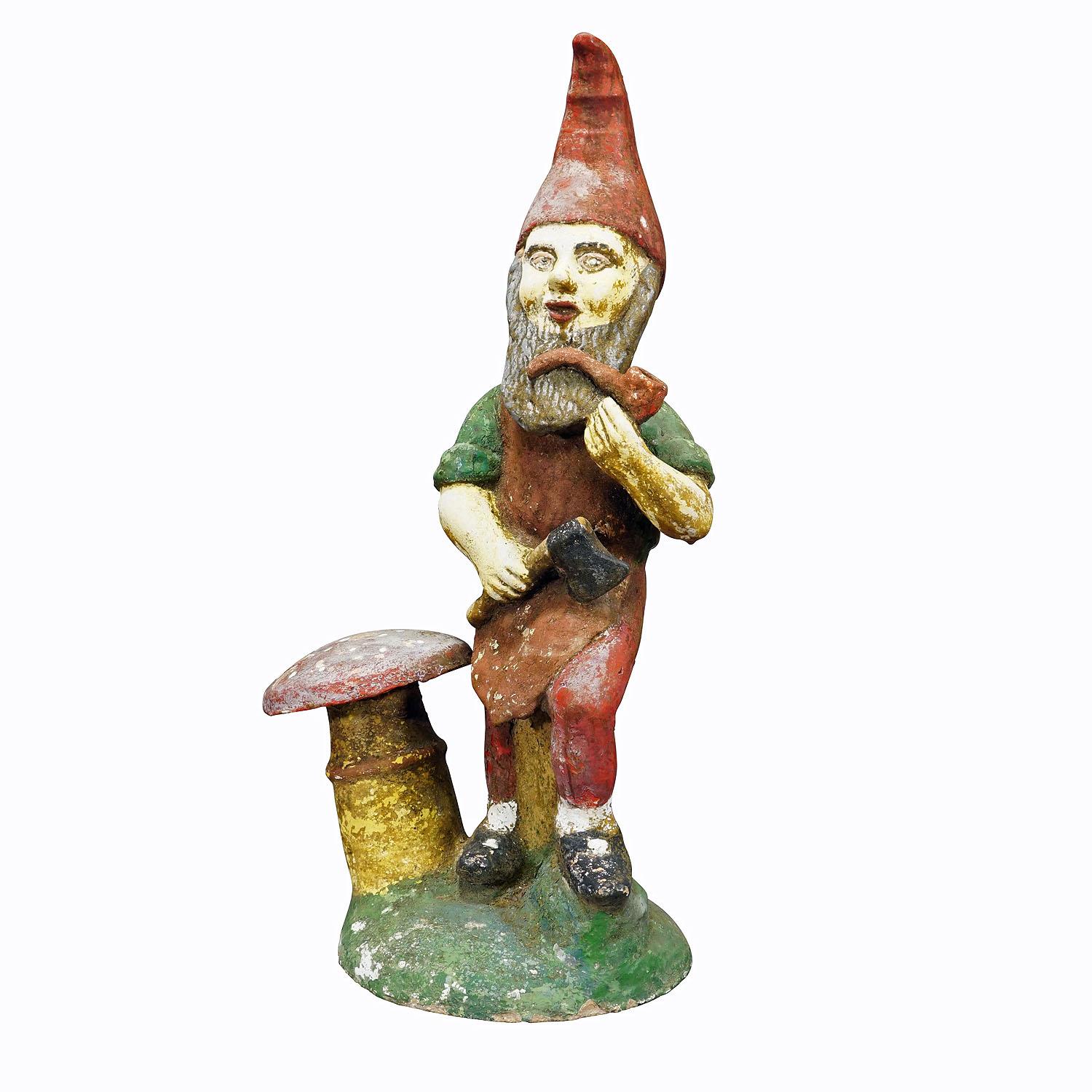 Large Terracotta Garden Gnome with Toadstool, Germany ca. 1920s

A large garden gnome from Germany, ca. 1920s. The gnome has a pipe and an axe in his hands and is standing next to a toadstool. Good used vintage condition with signs of wear