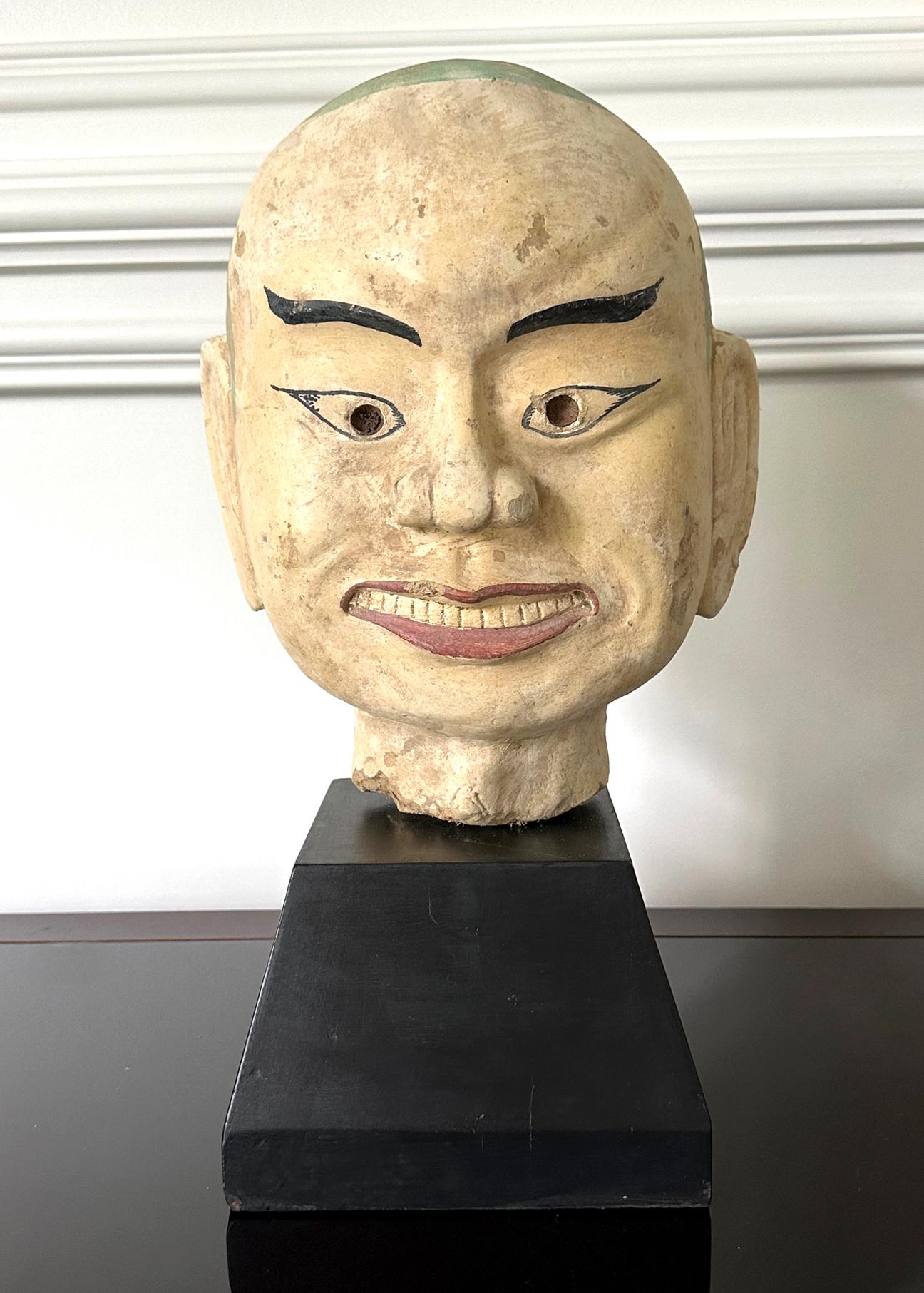 A large and heavy fired clay (terracotta) head of an Arhat (also known as Luohan in Chinese). The followers of Buddha who achieved the enlightenment, statues of Arhats are always found in the Buddhist temple, often surrounding the Buddha. The