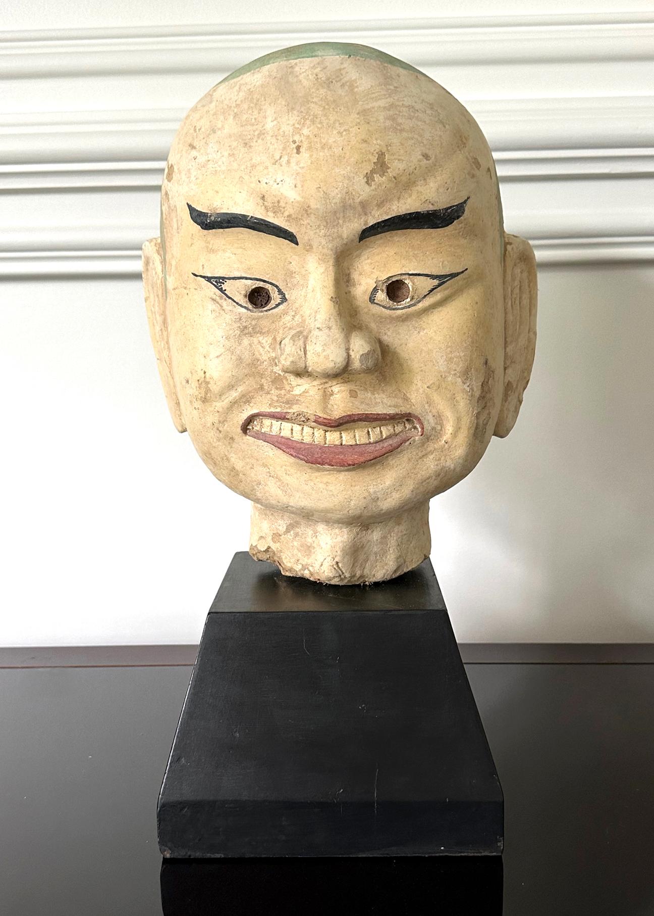 Ein großer und schwerer gebrannter Tonkopf (Terrakotta) eines Arhats (auf Chinesisch auch Luohan genannt). Die Anhänger des Buddha, die die Erleuchtung erlangt haben. Statuen von Arhats finden sich immer in buddhistischen Tempeln, oft in der Nähe