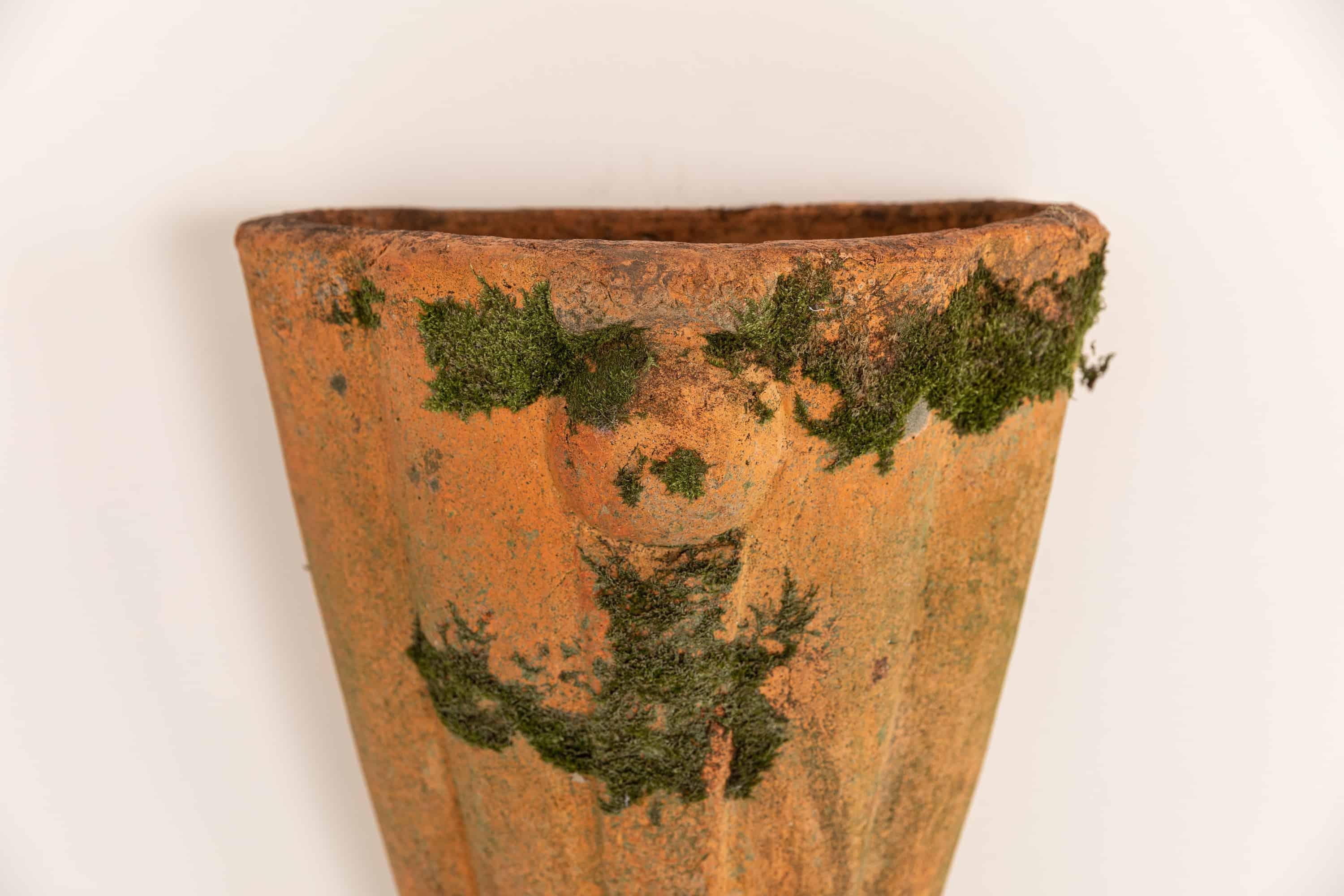 A very attractive concial wall mounted terracotta planter.

Hand made in terracotta which has taken on a beautiful colour over the years, complete with moss. Hole to rear allowing this to be wall hung.