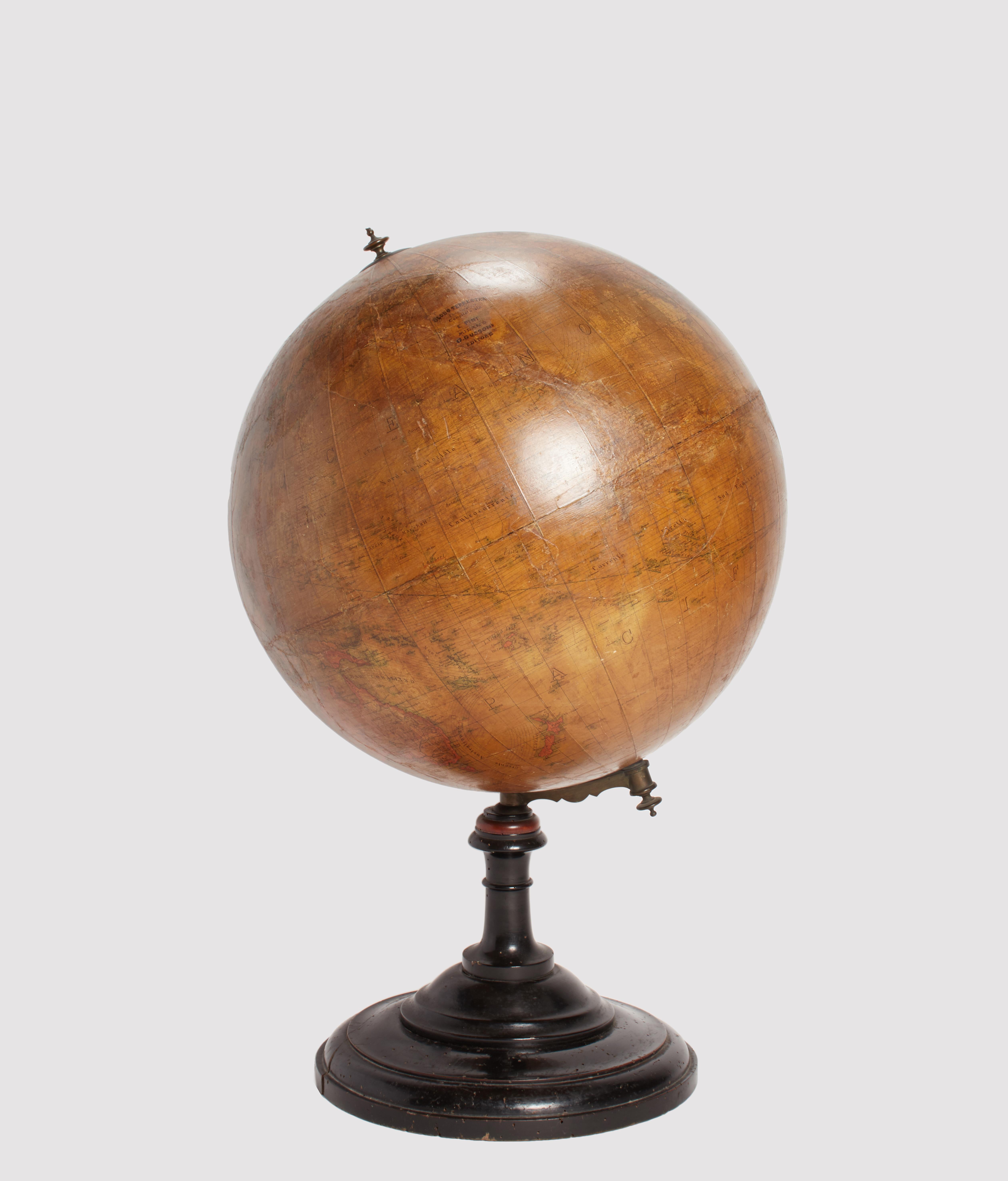 Large terrestrial globe (diameter 19,75”), made of paper mache on a wooden structure. The large turned base is made of black lacquered walnut wood. Cartography compiled by engineer E. Pini. Edited by G. Gussoni. Milan, Italy circa 1880.