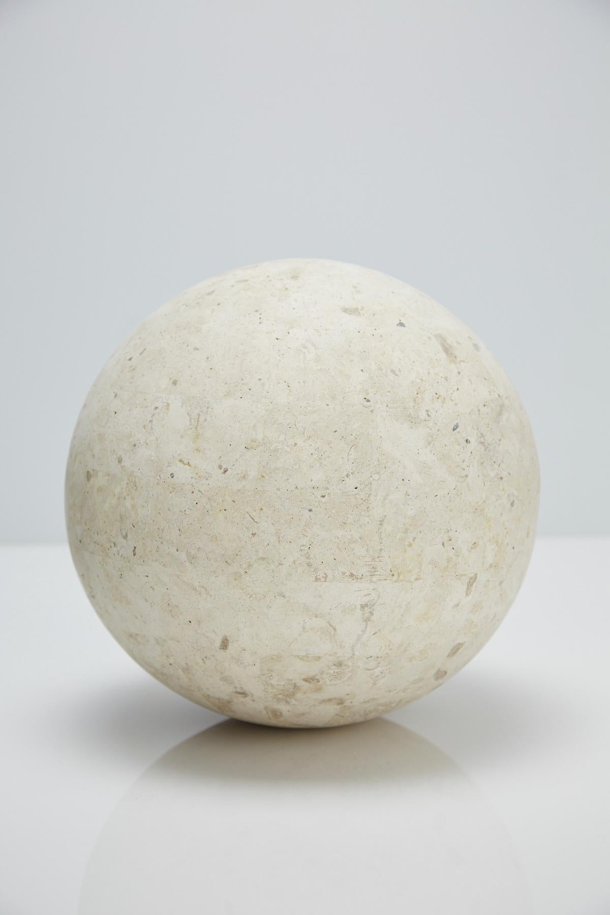 Large 10.5 in diameter Postmodern tessellated stone sphere executed in matte Mactan stone over a fiberglass body.

Pair available.

All furnishings are made from 100% natural Fossil Stone or Seashell inlay, carefully hand cut and crafted