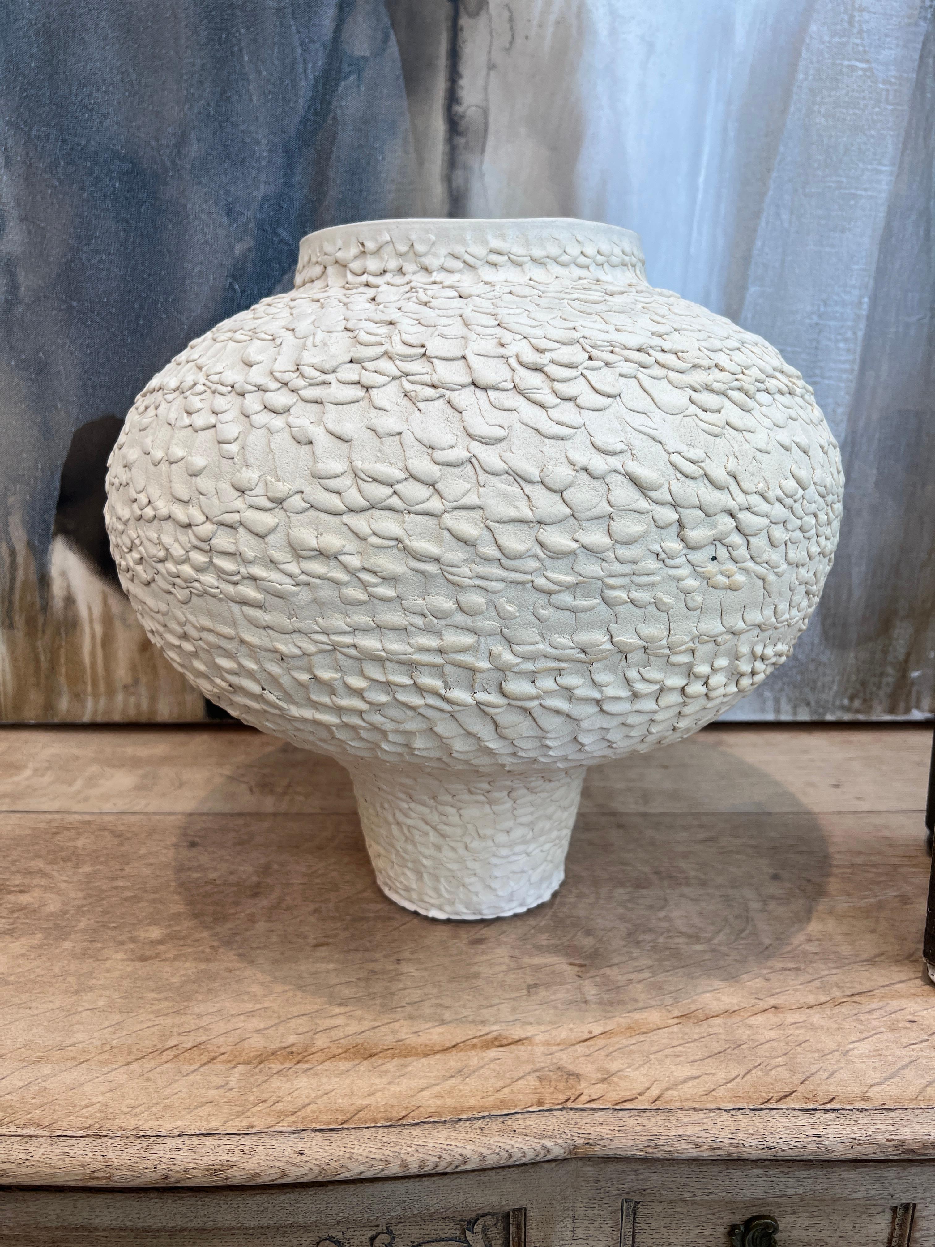 Hand crafted textural vase in cream color.