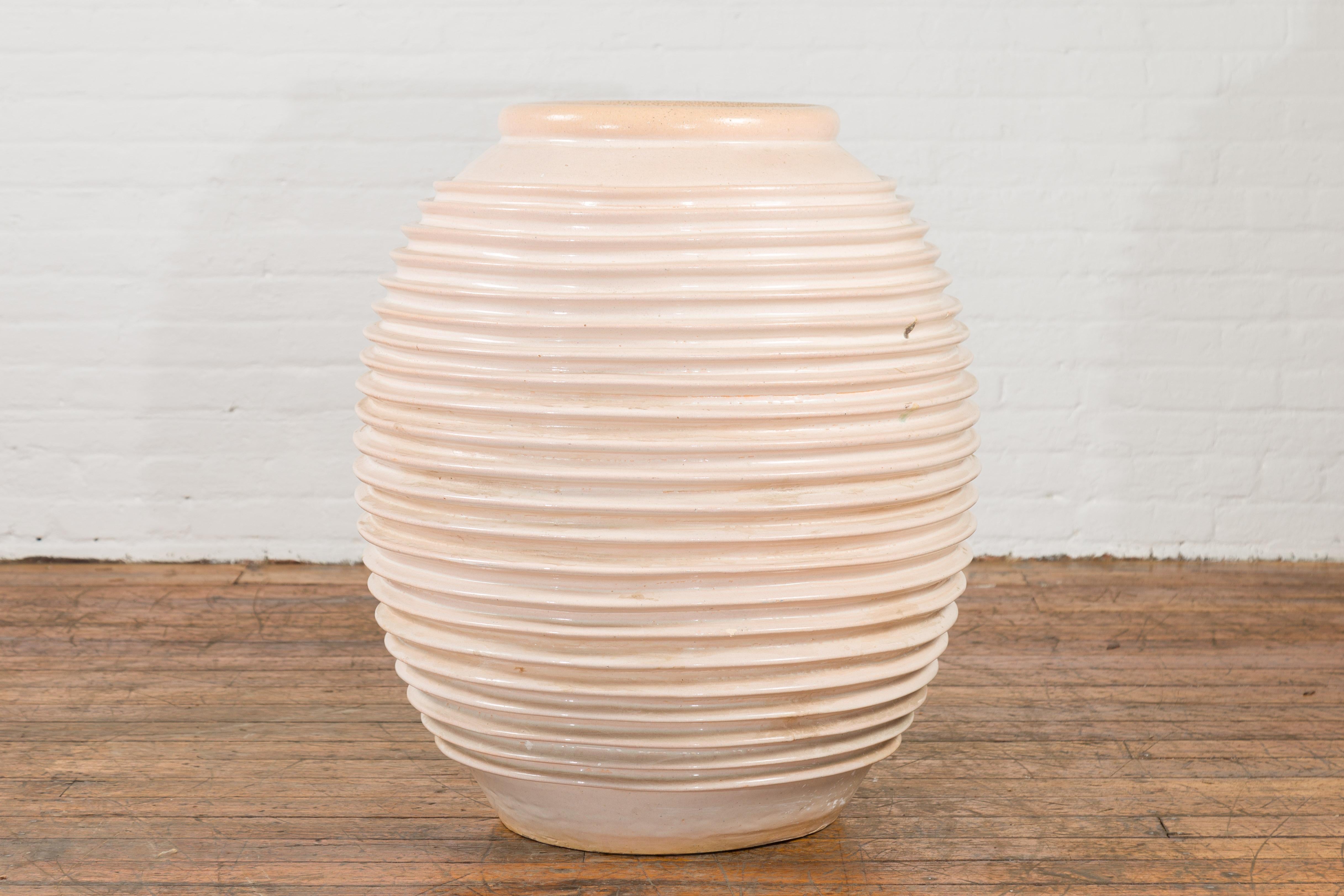 Ceramic Large Thai Cream Toned Vase with Graduated Lines Décor and Light Pink Undertone For Sale