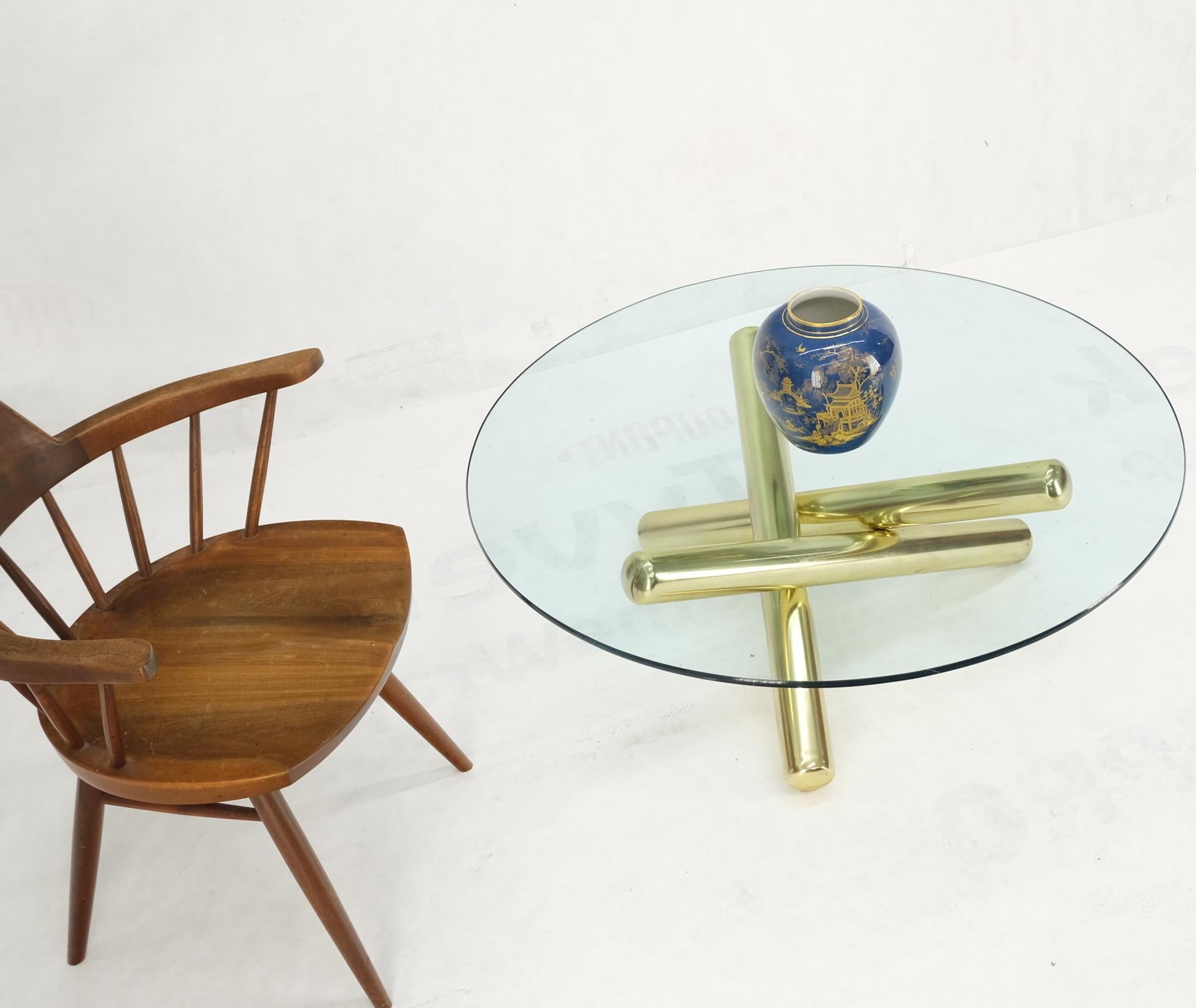 Large thick brass spikes to form jack tripod base round glass top coffee table.