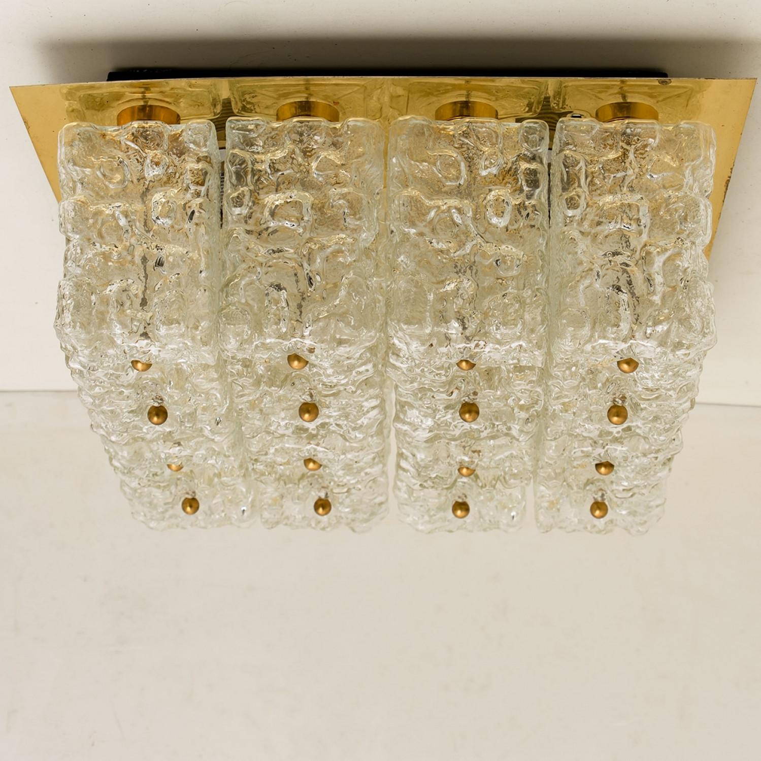 Mid-Century Modern textured ice glass light fixture by German manufacturer Kaiser, circa 1965.

This ceiling light, often mistakenly attributed to Kalmar, features 16 glass blocks mounted on a golden brass backplate.

Well- wired, cleaned in full
