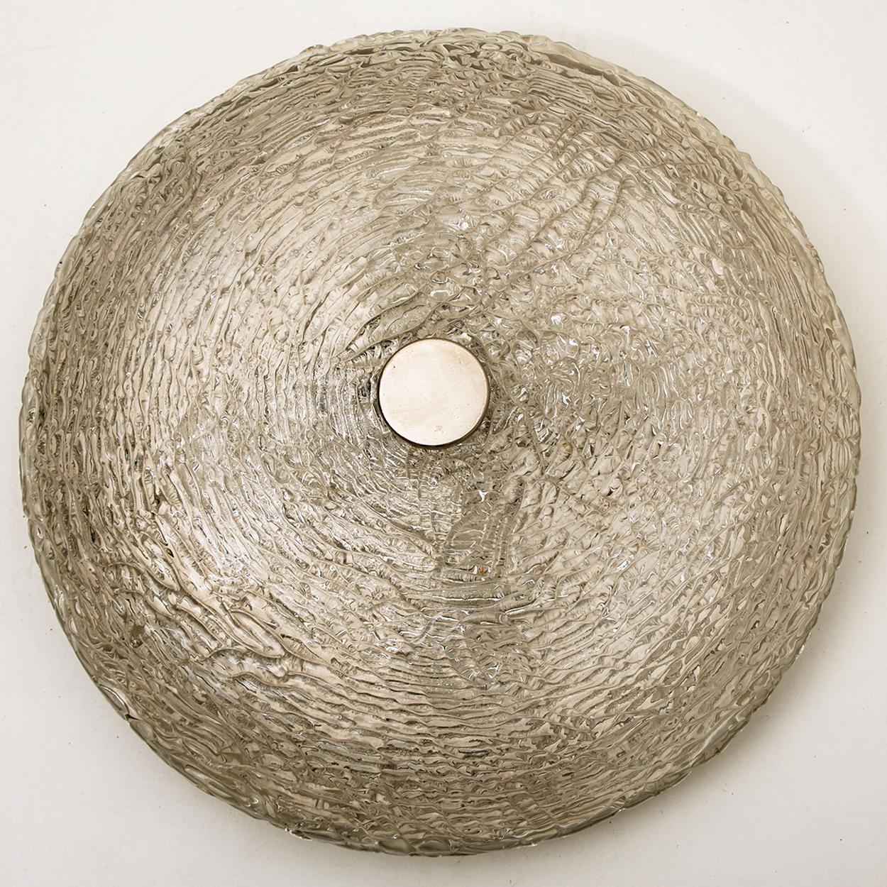 Mid-Century Modern textured ice glass light fixtures by manufacturer Kaiser, circa 1965. Clean, simple but high-end design. Illuminates beautifully. Each light fixture, often mistakenly attributed to Kalmar, features a huge handmade thick textured