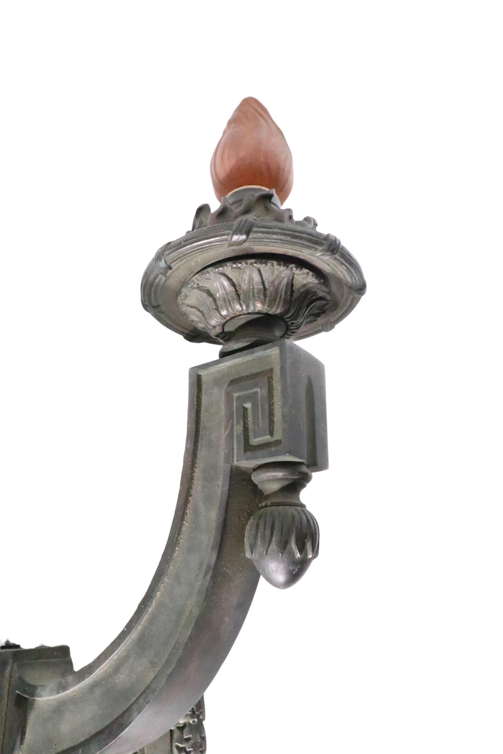 Spectacular cast brass, or bronze, three arm wall appliqué, probably from a bank, public building, or other commercial building. The sconce is in exceptional aged Verdigris finish, it is newly professionally rewired and is ready to install. Executed