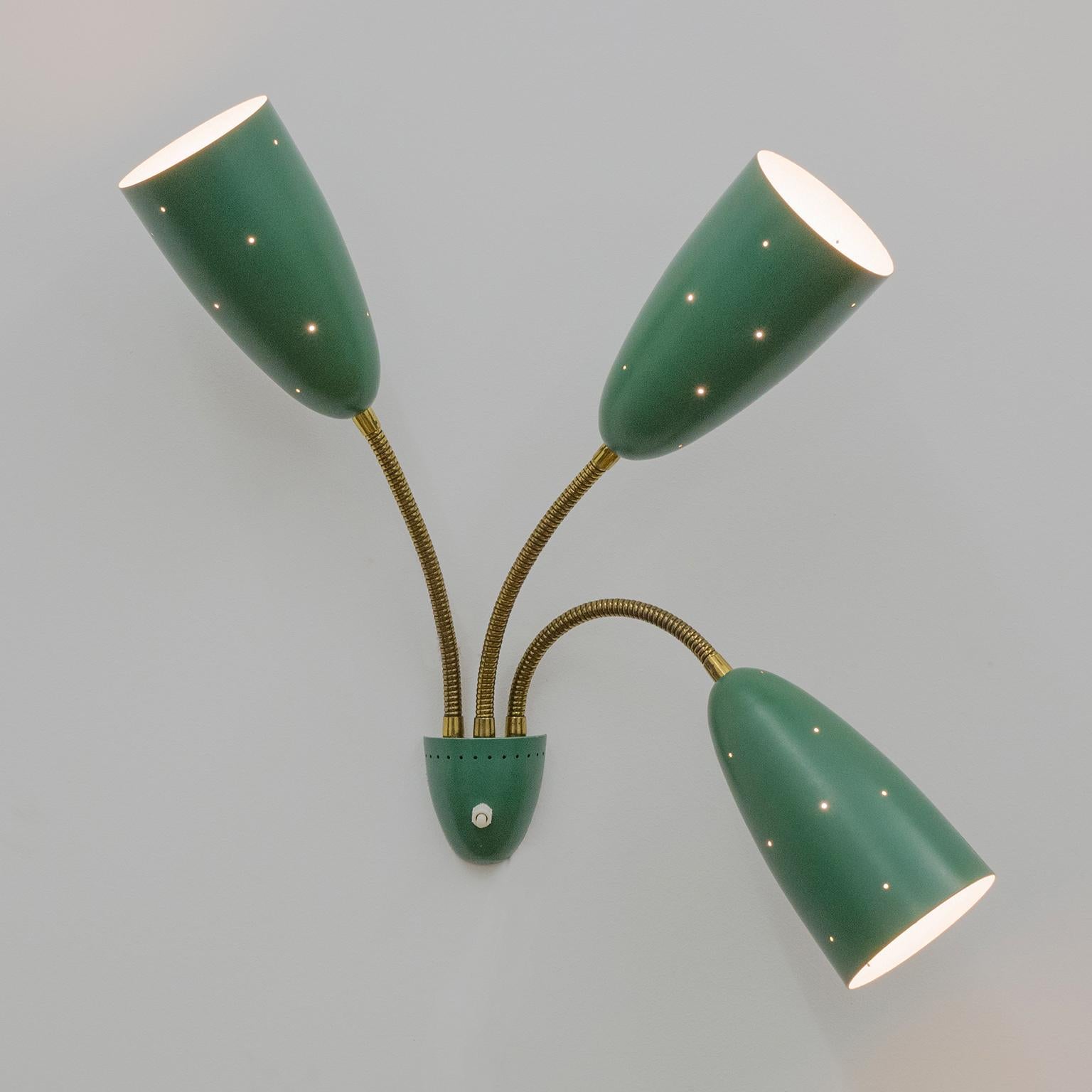 Beautiful midcentury wall light with three large pierced cones on brass 'goose necks'. Wonderful original condition with only very minor usage signs on the original lacquer. The cones measure 7.5inches/19cm in length and have a diameter of