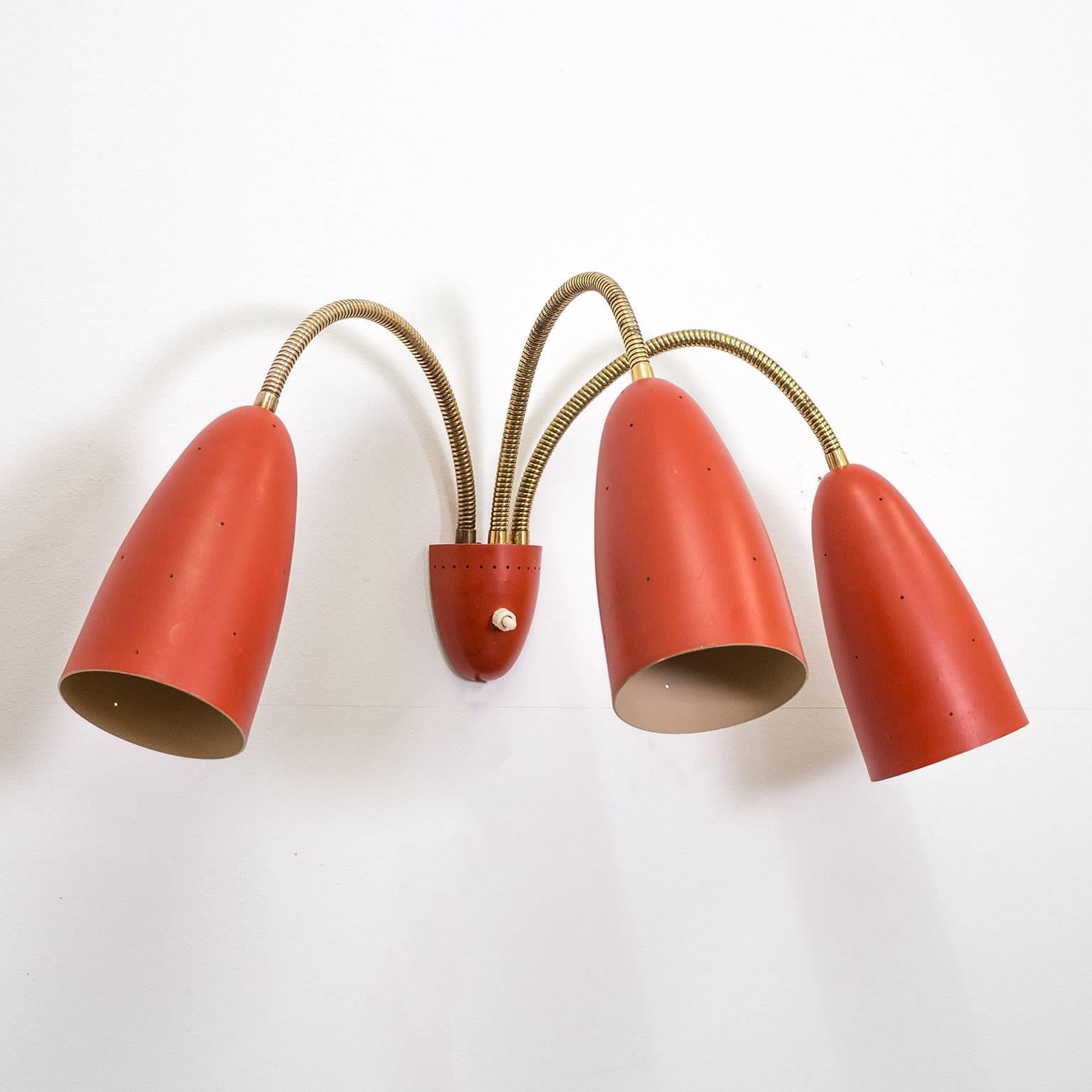Beautiful midcentury wall light with three large pierced red cones on brass 'goose necks'. Wonderful original condition with only very minor usage signs on the original lacquer. The cones measure 7.5inches/19cm in length and have a diameter of