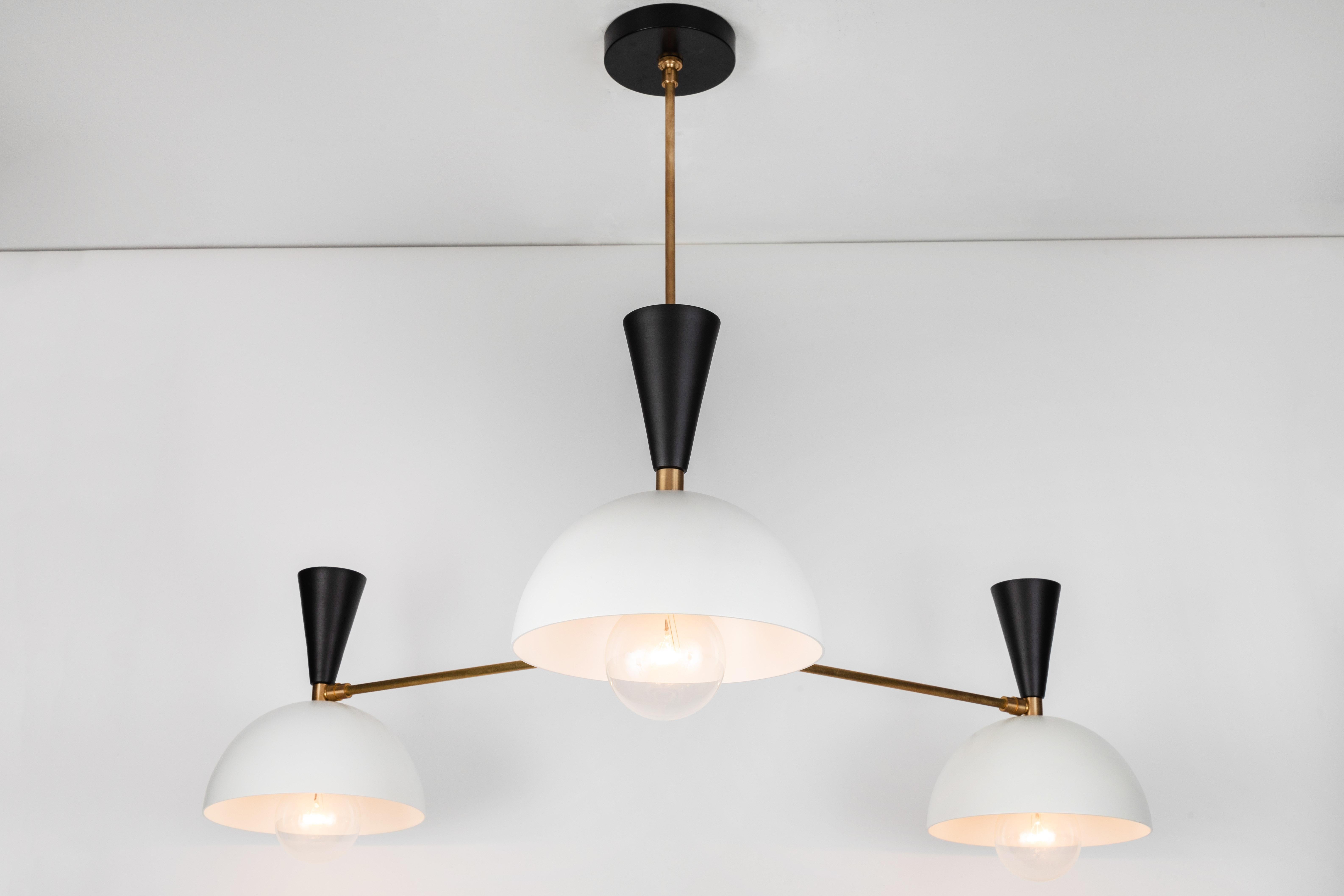 Large three-cone 'Lola II' chandelier in black, white and brass. 

Hand-fabricated by Los Angeles based designer and lighting professional Alvaro Benitez, this highly refined chandelier is reminiscent of the iconic midcentury Italian designs of