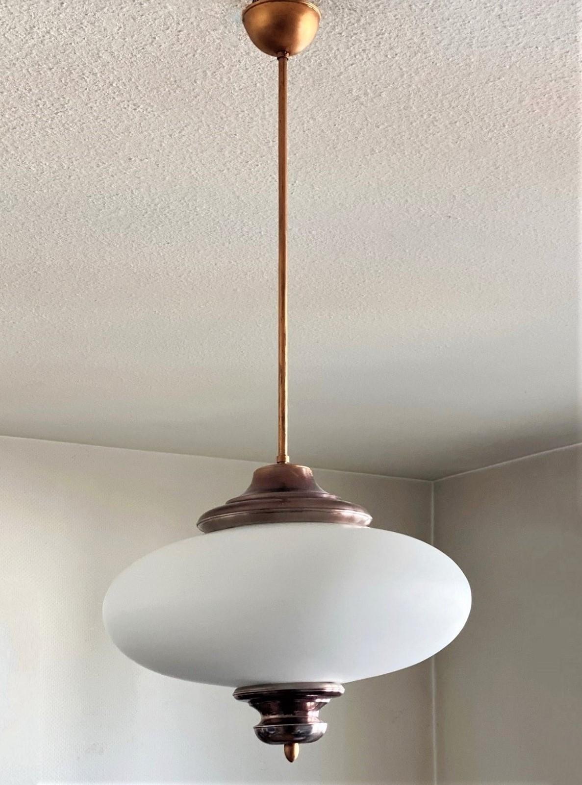 Pendant by Arredoluce manufactured in Italy, circa 1950. Large brushed satin glass diffuser, metal copper-plated mounts. It takes three E27 bulbs maximum 60w each bulb, rewired and ready to hang.
Measures: Diameter 16