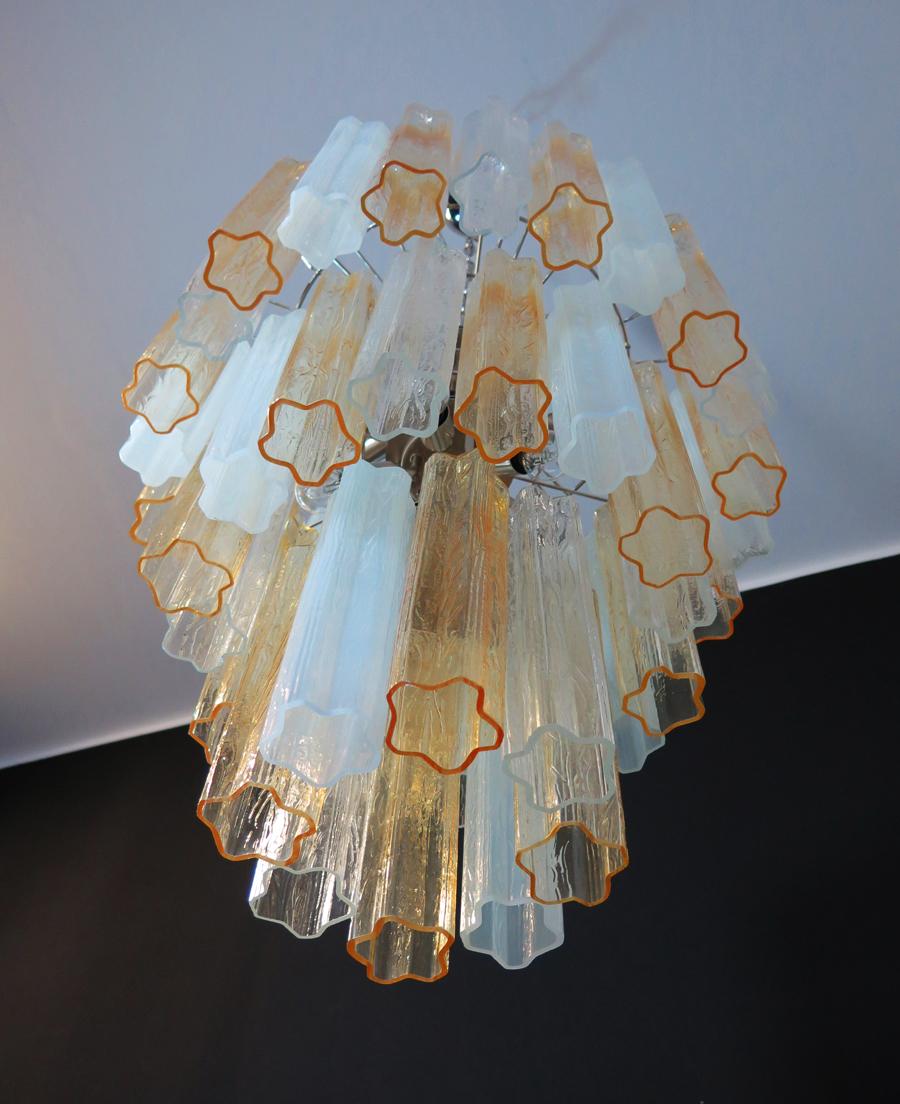 Italian vintage chandelier in Murano glass and nickel-plated metal structure. The Armor polished nickel supports 48 large glass tubes in a star shape. The glasses have three beautiful colors, amber, transparent and opal silk; object of rare