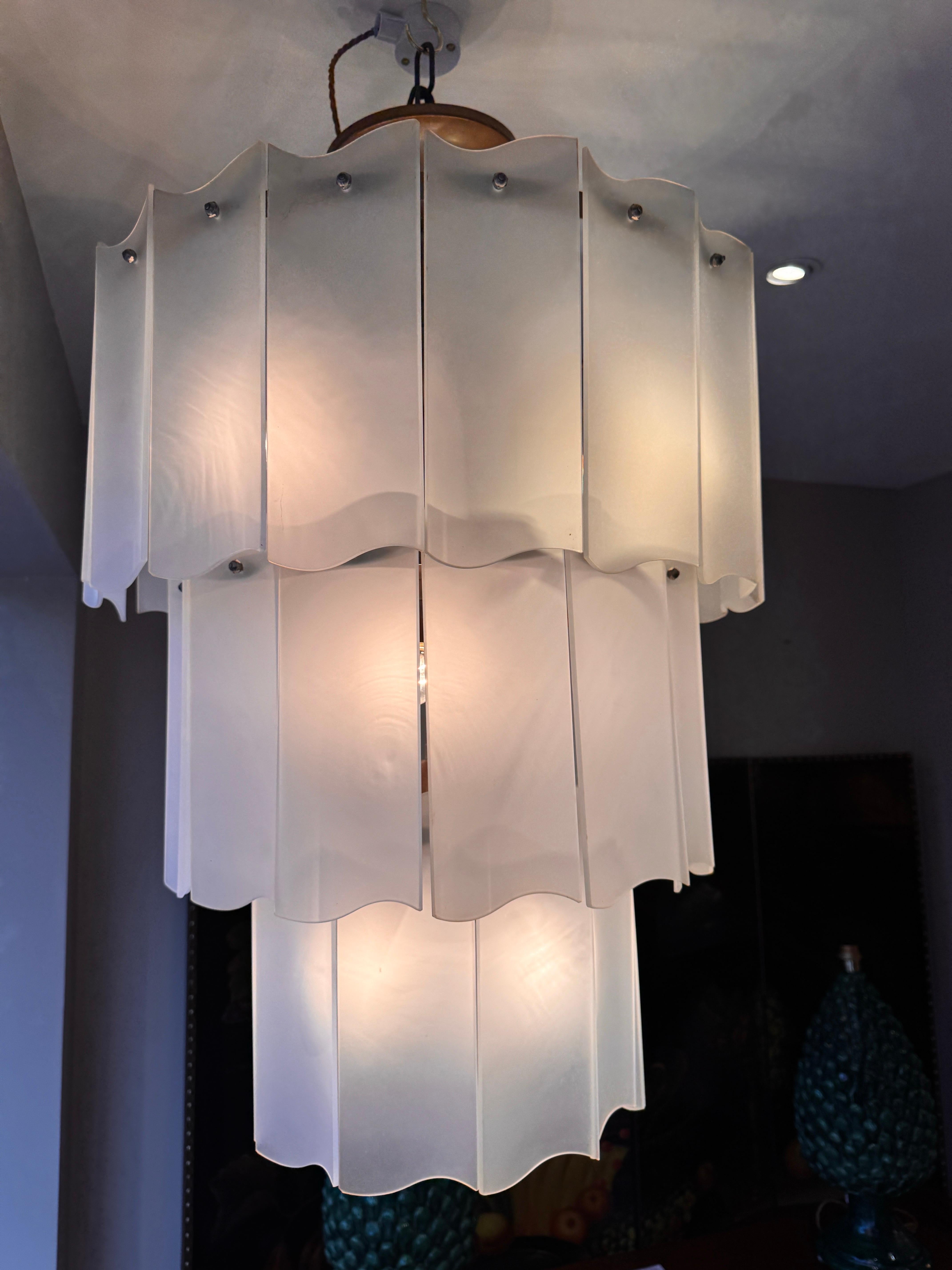 A beautiful three tiered cascading Murano frosted glass chandelier supported by a large brass structure with nine bulb holders. Designed by Carlo Nason C1960s 