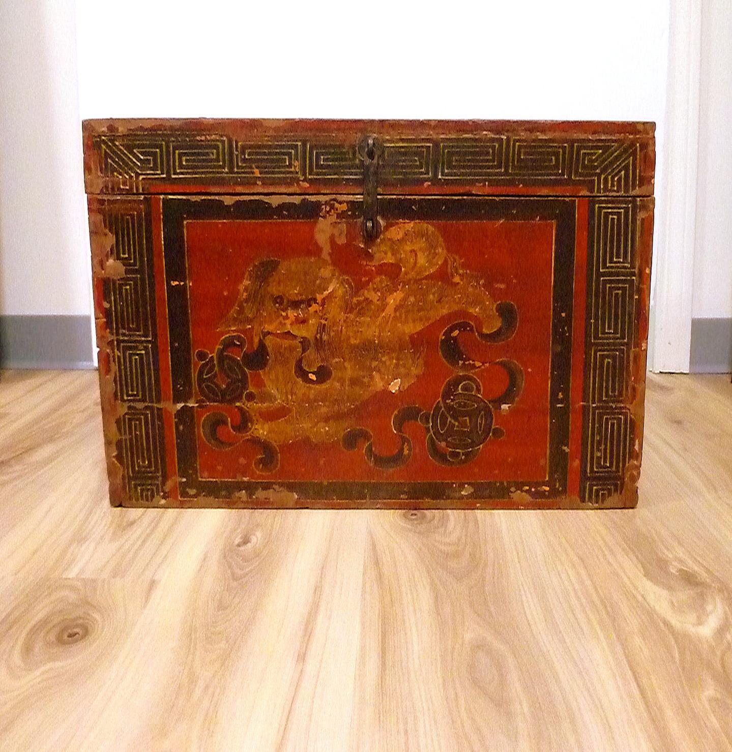 Boîte tibétaine de grande taille avec un lion foo peint jouant et poursuivant une balle.
Motif original peint