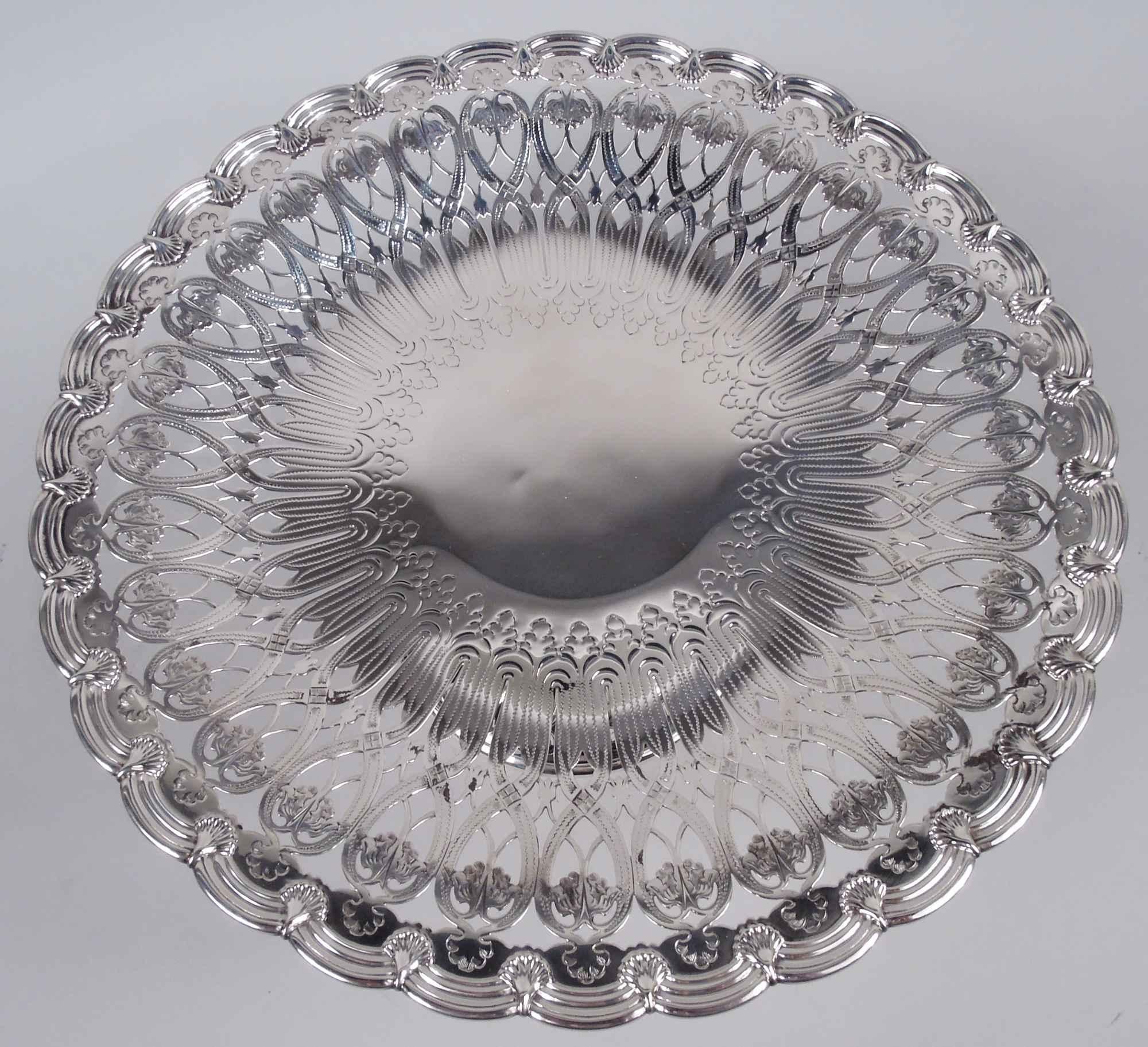 Edwardian Art Nouveau sterling silver compotes. Made by Tiffany & Co. in New York, ca 1915. Round and shallow bowl on upward tapering shaft flowing into raised foot. Well center solid with engraved leaves and tendrils surrounded by pierced