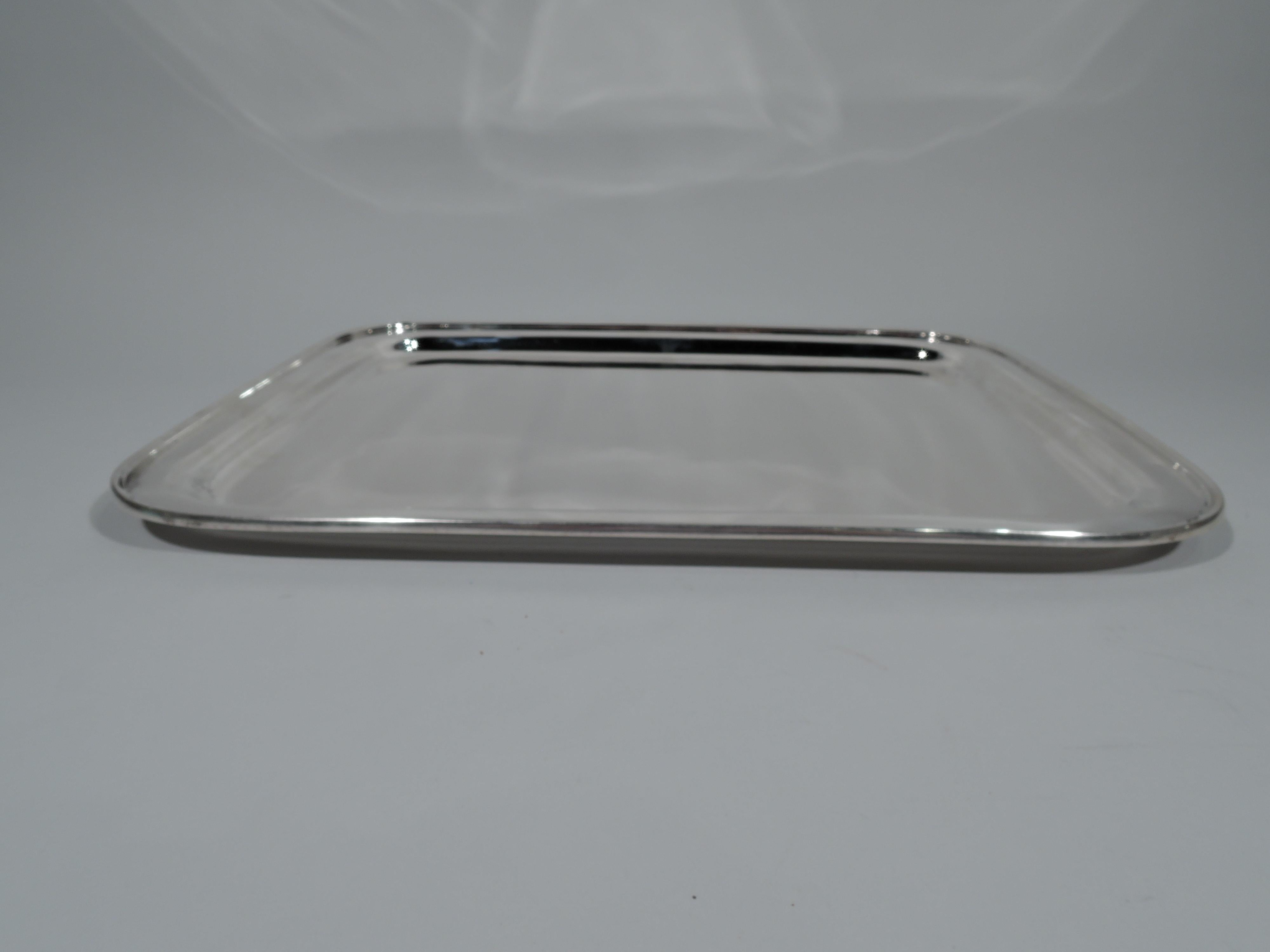 Art Deco sterling silver serving tray. Made by Tiffany & Co. in New York, circa 1937. Rectangular with curved corners and molded rim. Hallmark includes pattern no. 22552 (first produced in 1937). Weight: 61.5 troy ounces.
