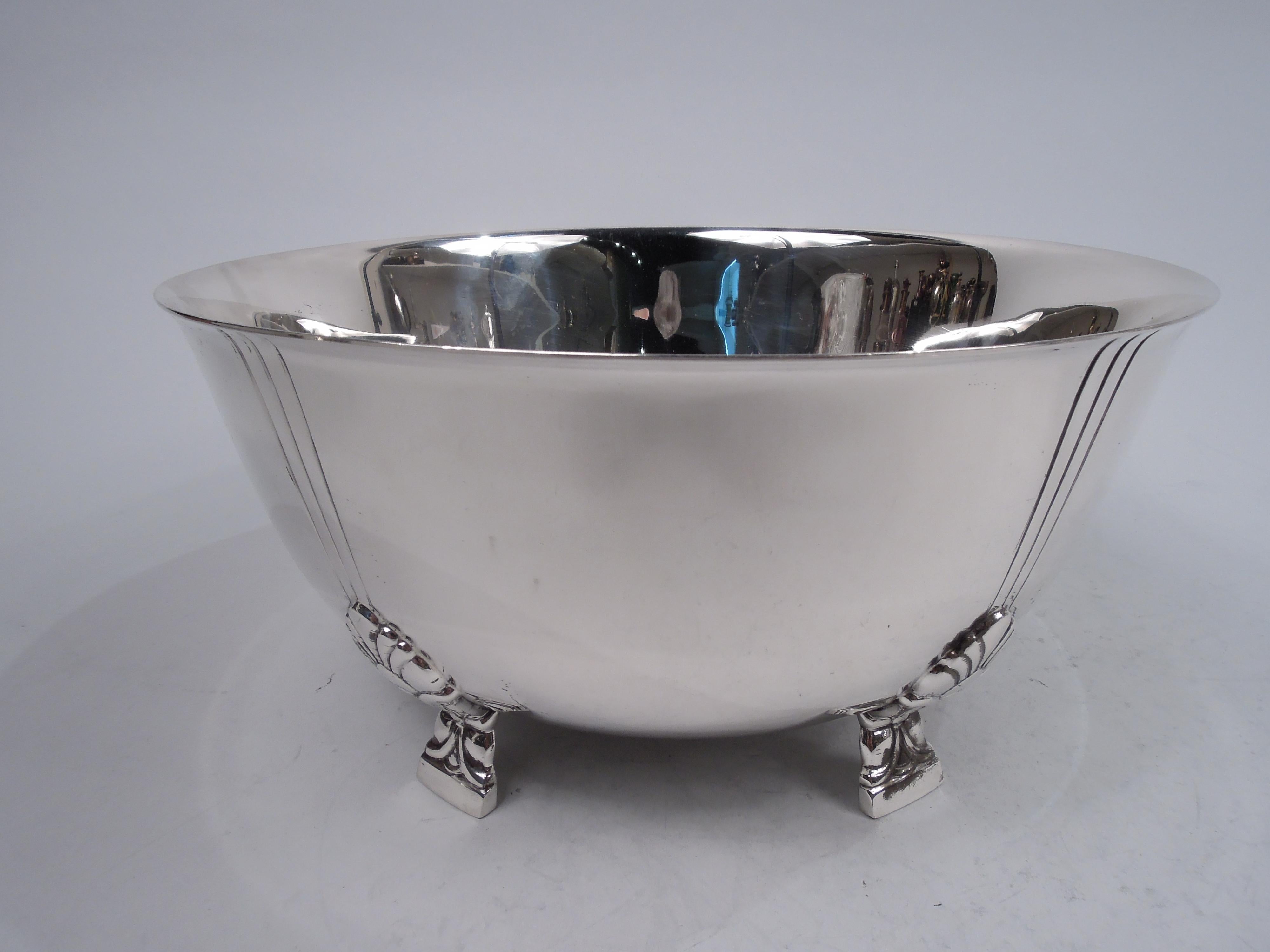 Palmette sterling silver bowl. Made by Tiffany & Co. in New York. Curved sides and flared rim. Rests on 5 side-mounted stylized floral supports. Each support radiates 3 incised vertical lines. An early piece in this pattern (no. 23239), which was