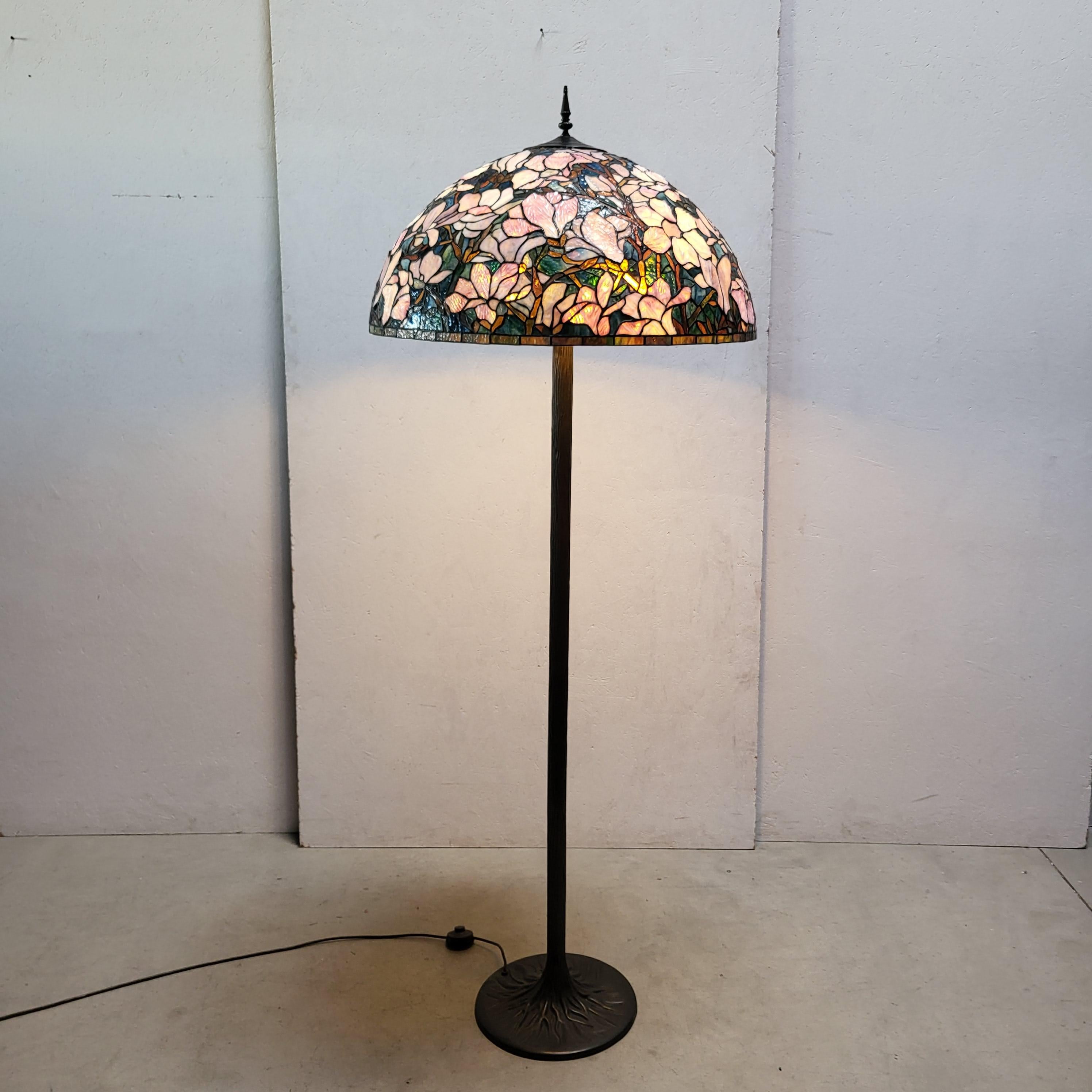 Stunning and amazing floor lamp in the manner of Tiffany Studios. 
Very impressive handmade lamp with a wonderful base.
 
Very fine handwork, colourful glass.

The lamp has an amazing warm light and is a wonderful art object.
It comes in a very good