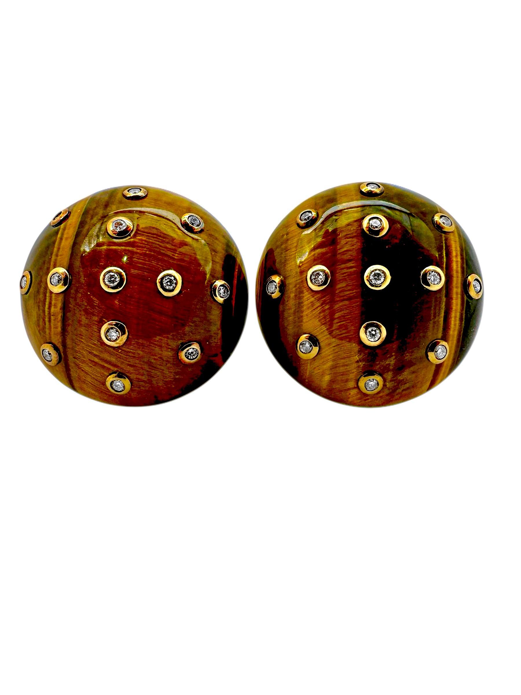 This striking pair of bombe dome Tiger's Eye earrings are
artfully dotted with twenty six round brilliant cut diamonds set in 18K yellow gold bezels. Each bombe dome, crafted from a single slab of natural Tiger's-Eye, measures a full 1 3/16 inches