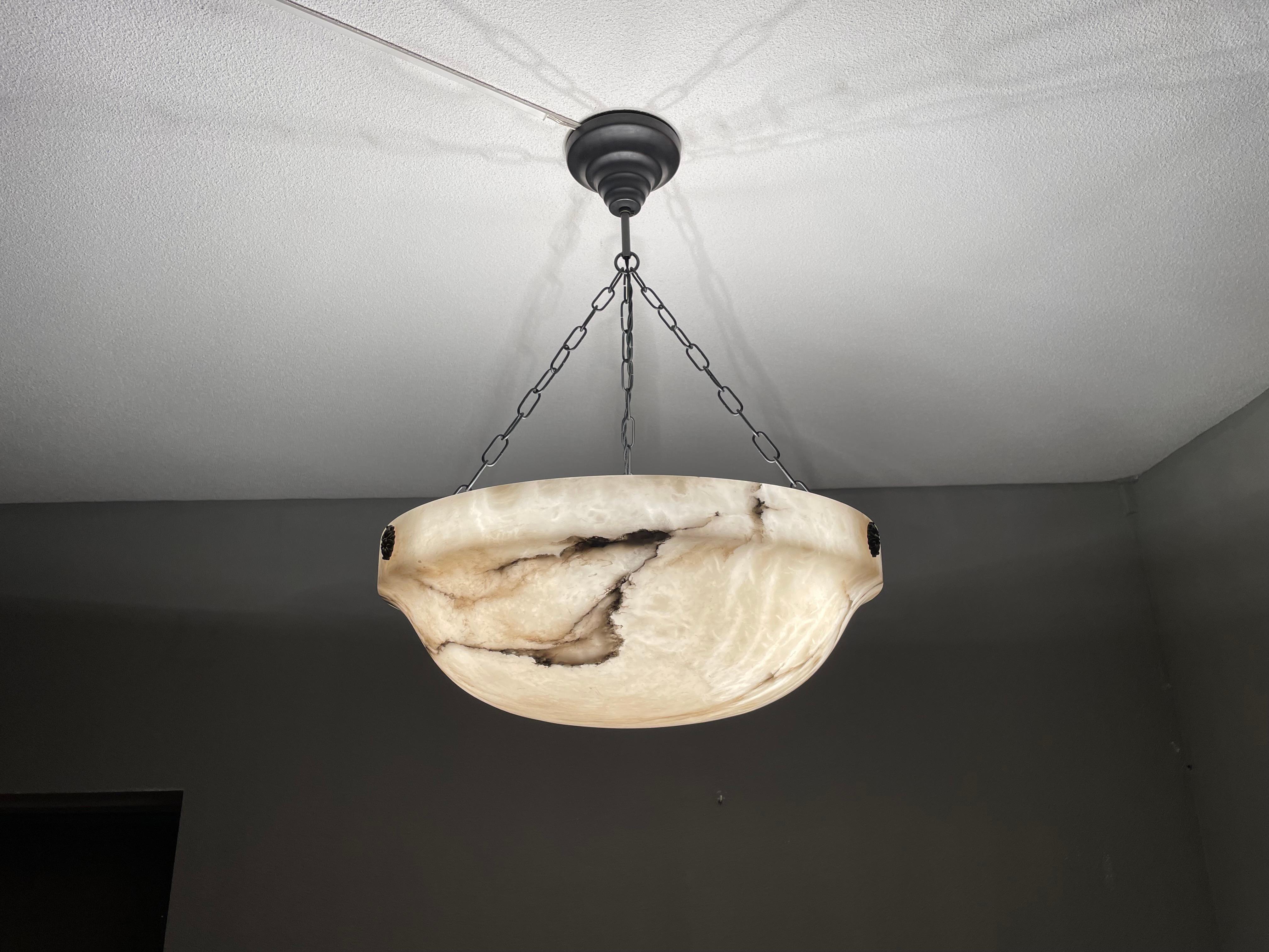 Antique and large alabaster chandelier.

Thanks to its large size, its truly deep bowl shade and its timeless design this three light alabaster chandelier too is bound to light up someone's days and evenings soon. It is in good condition and the