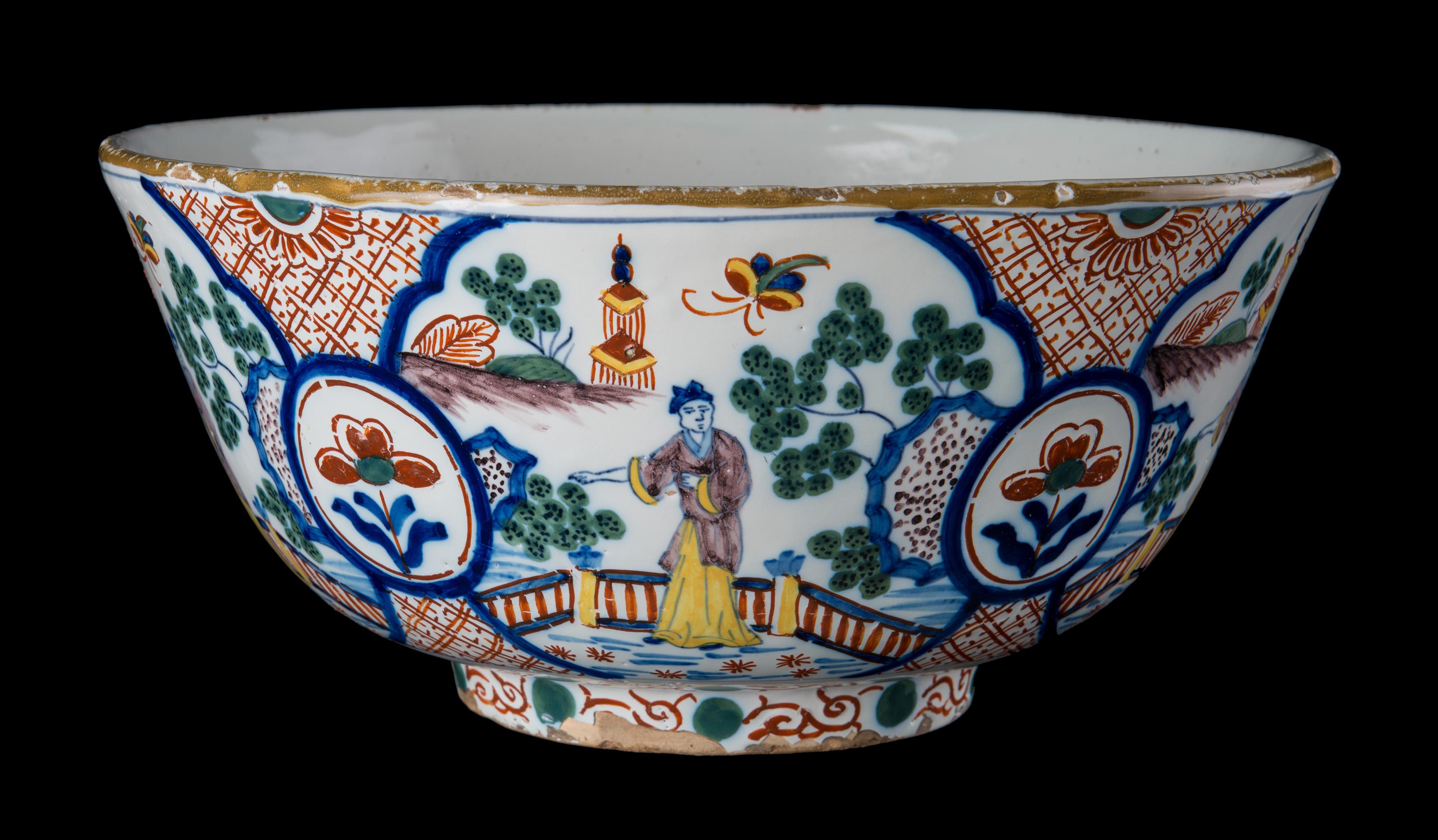 Large tin-glazed bowl in the style of old Dutch Delftware, painted with a polychrome chinoiserie decor. Manufactured at the Geo Martel company in Desvres, Northern France at the beginning of the twentieth century. 
This large Delft bowl is in very