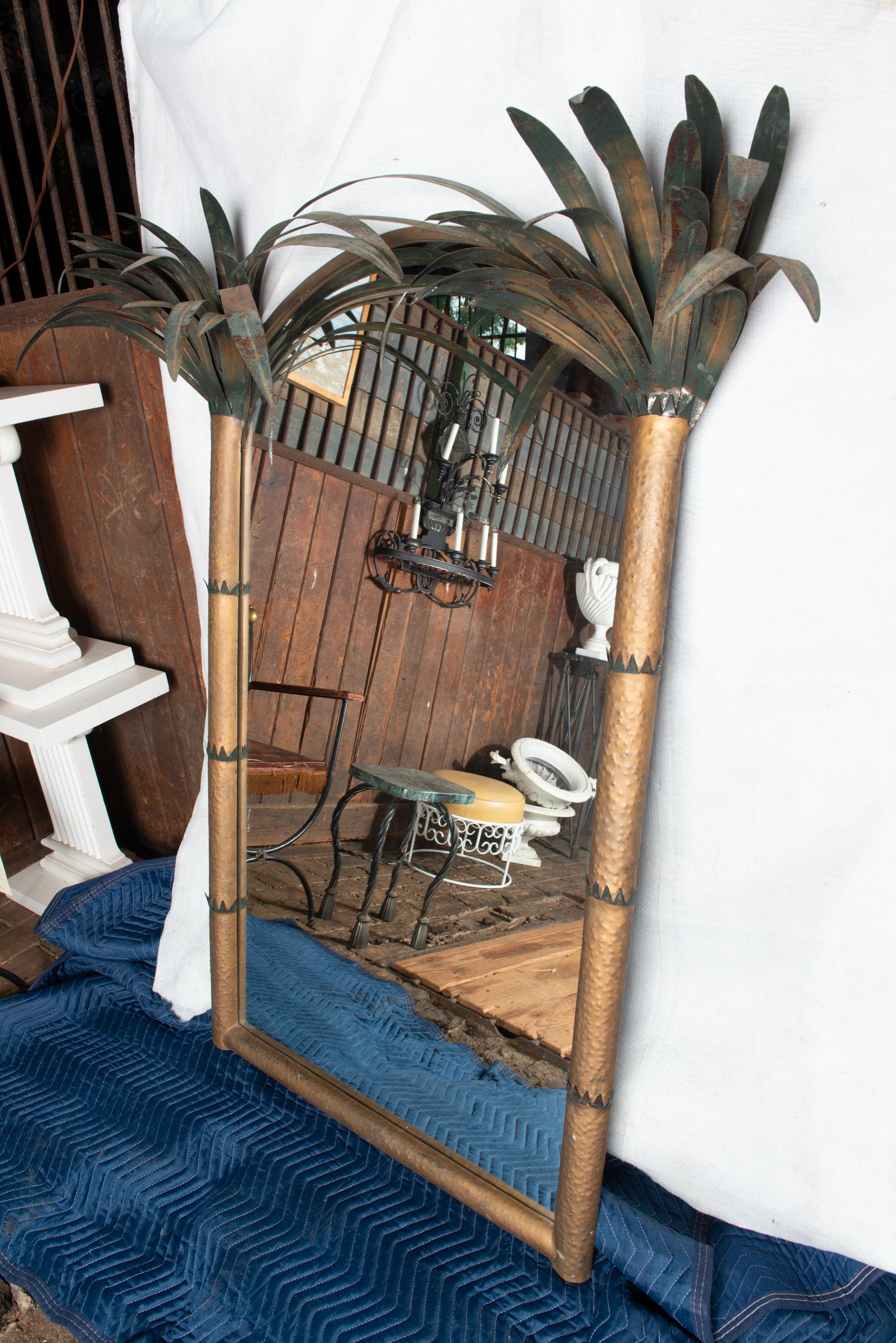 A large tole style metal double palm tree wall mirror. Mirror width is 34
