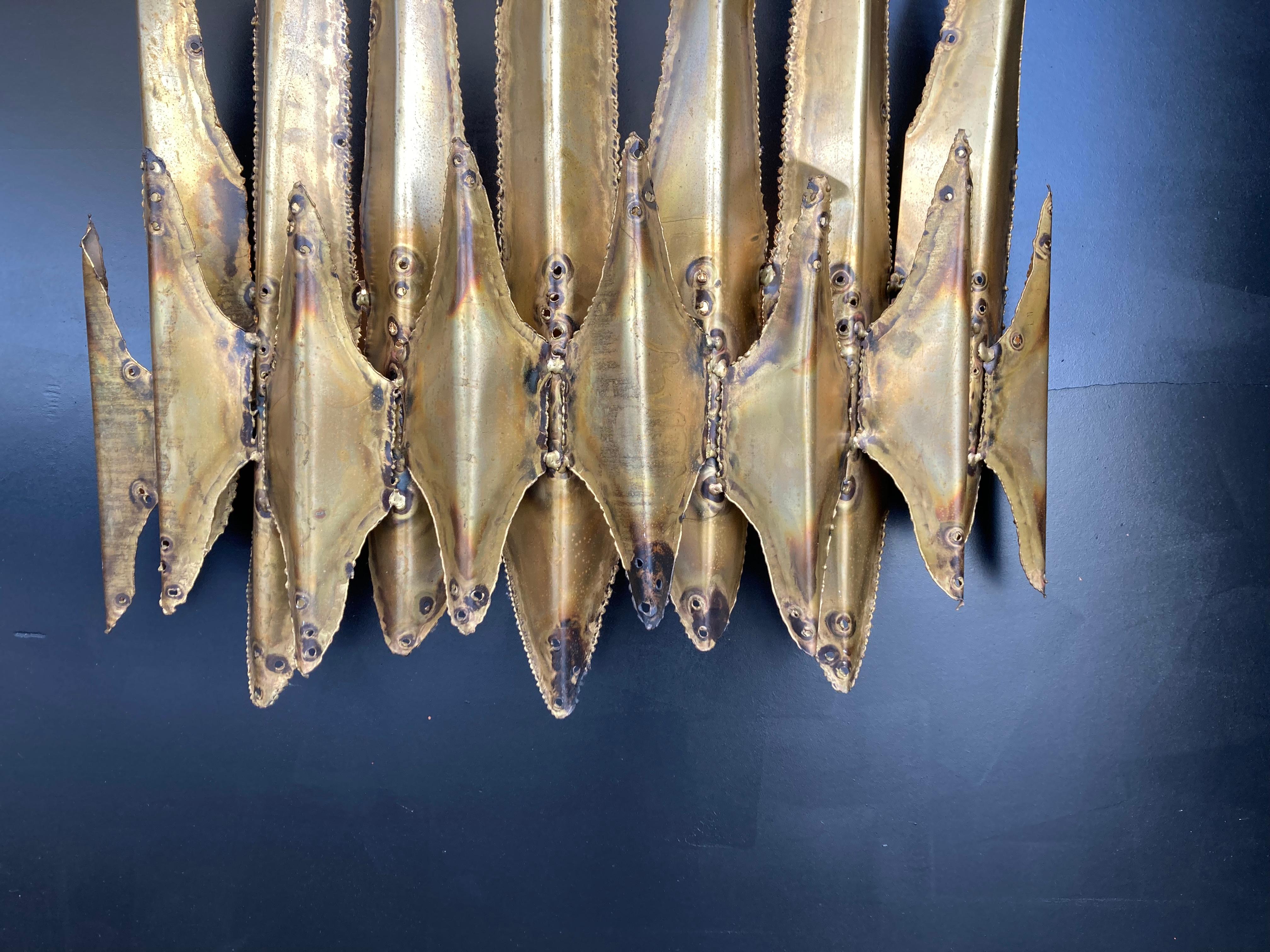 Large torch cut and patinated brass wall lamp by Tom Greene for Feldman.