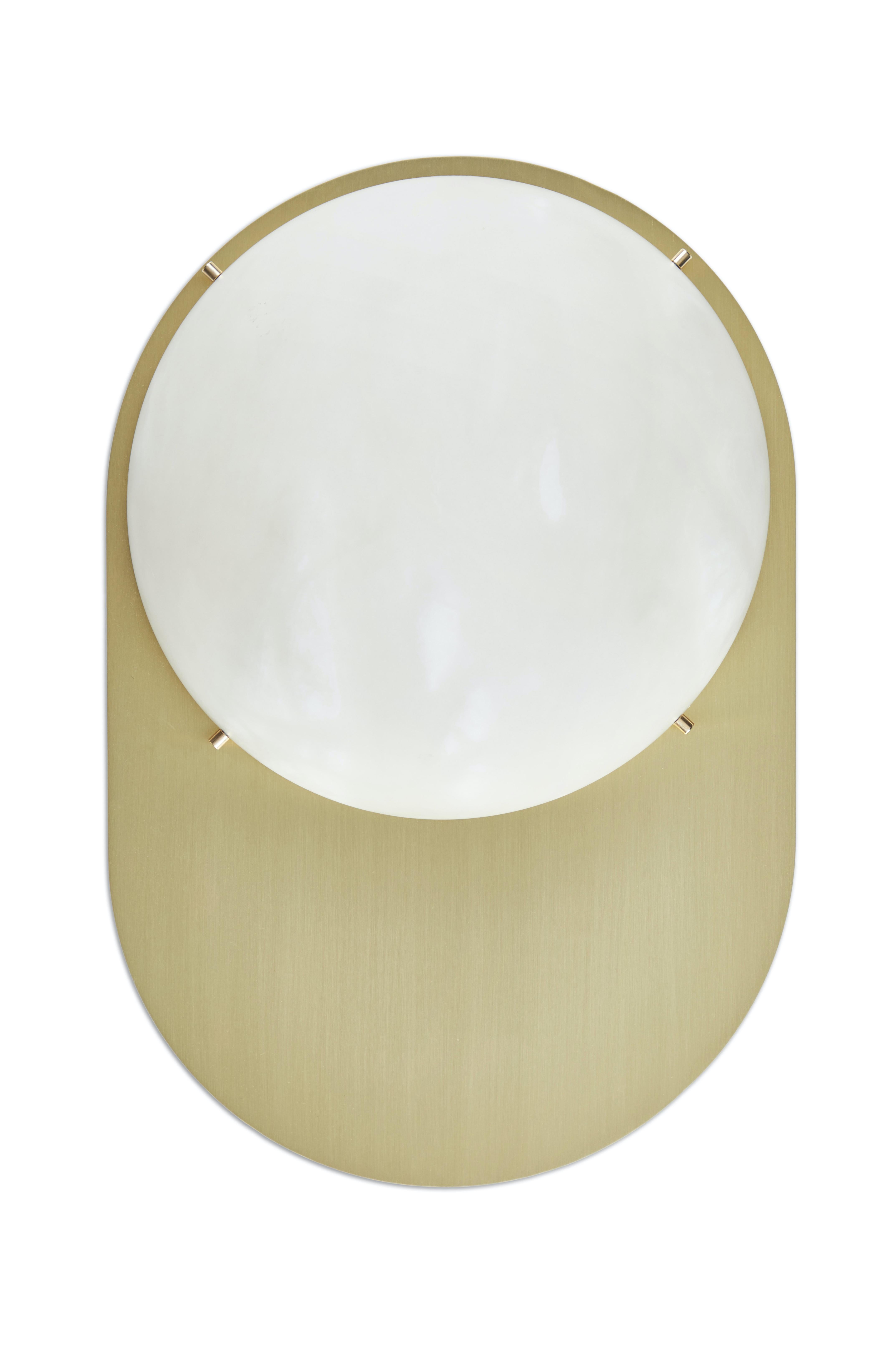 Large 'Toogle' sconce in brass and alabaster. Handcrafted in Los Angeles in the workshop of noted French designer and antiques dealer Denis de le Mesiere, who fabricates his highly refined original designs with scrupulous attention to detail and