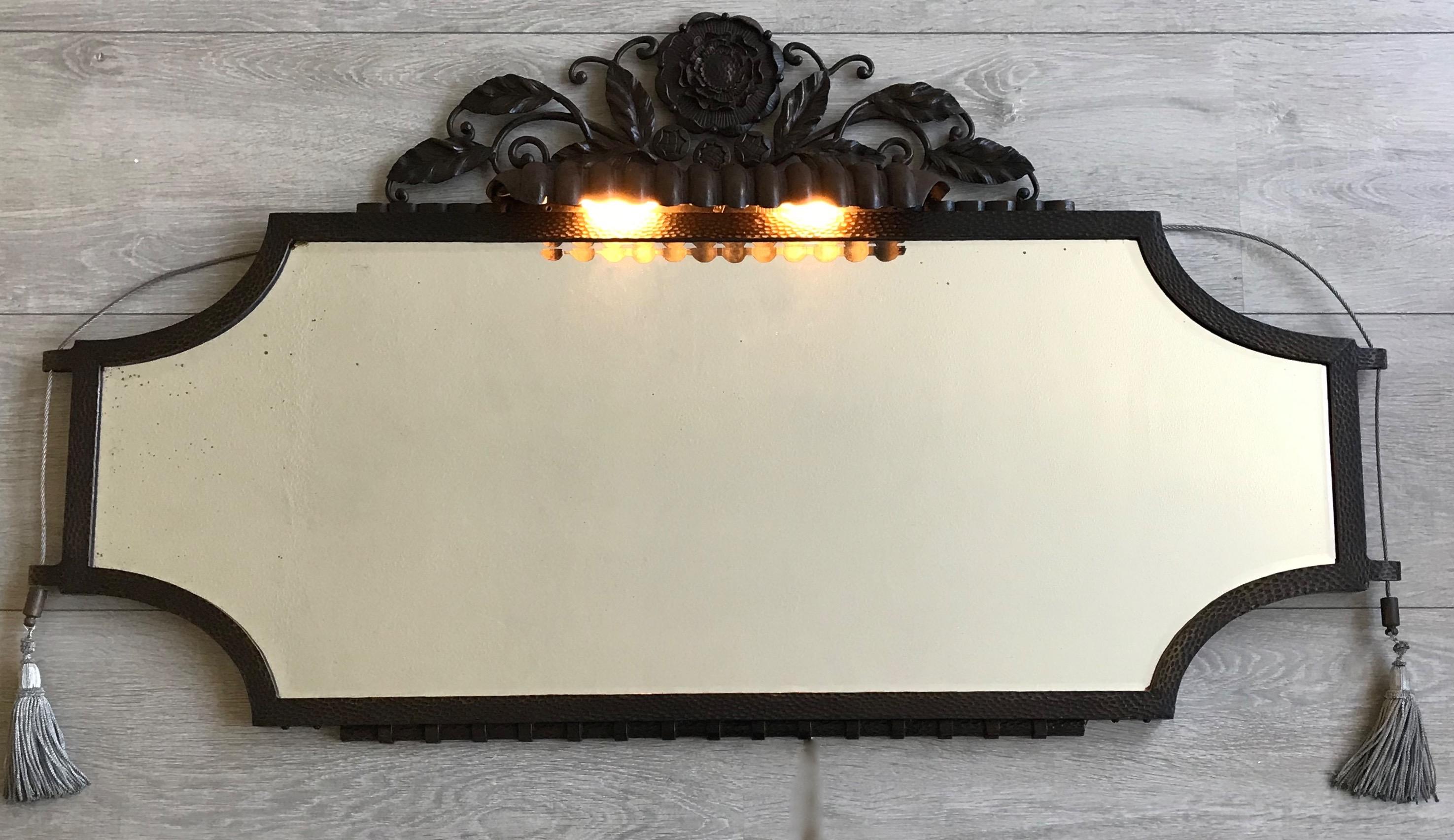 Rare and stunning Art Deco wall mirror, possibly by Edgar Brandt.

This striking Art Deco wall mirror is part of a stunning two-piece French Art Deco set consisting of a side table and this masterful wall mirror. This marvelous Art Deco mirror is in