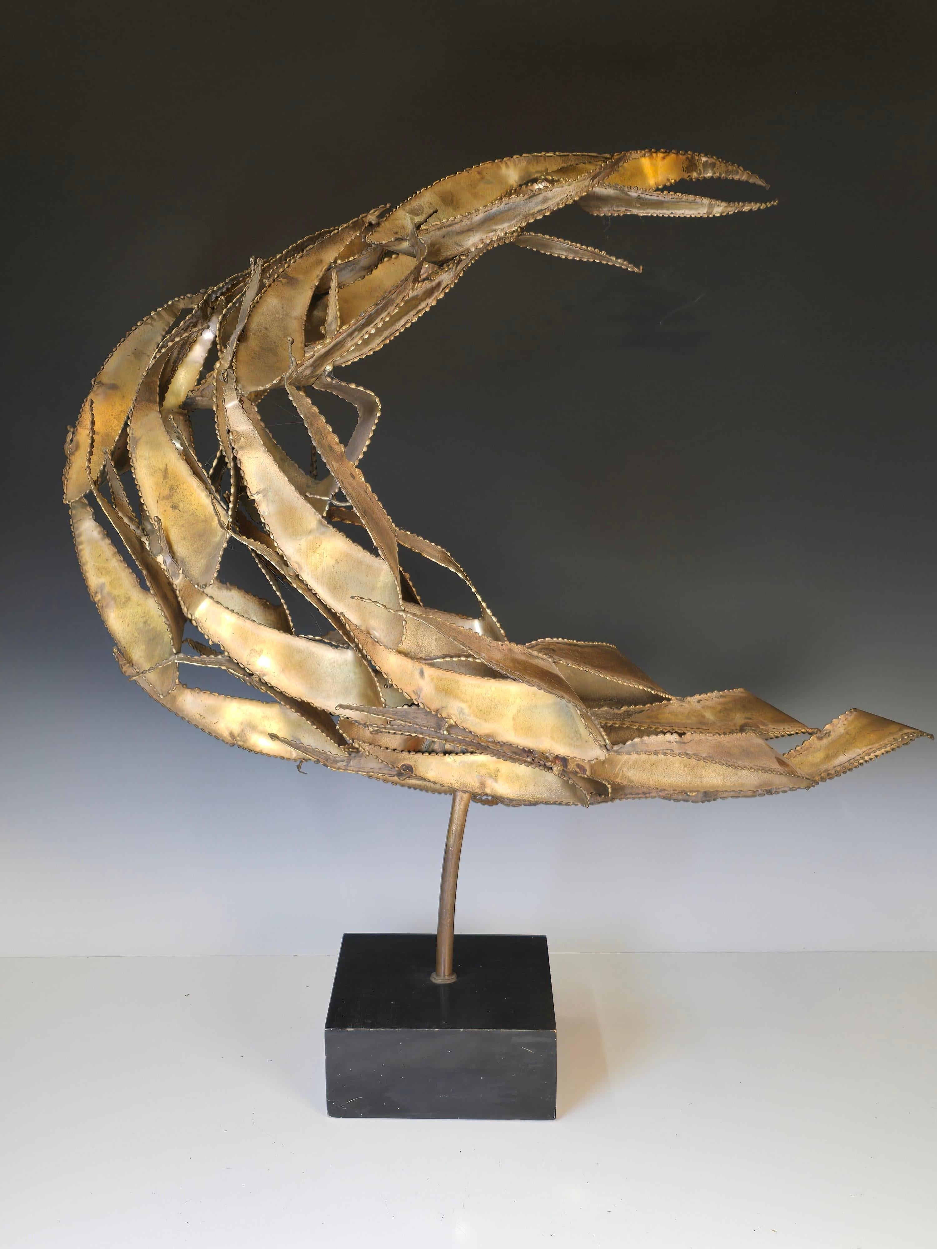 A large table top brutalist torch cut and welded sculpture mounted in an ebonized wood base.   Similar in style but more stylish than the pieces by Curtis Jere.   This particular design is often attributed to Bijan but the quality is better than