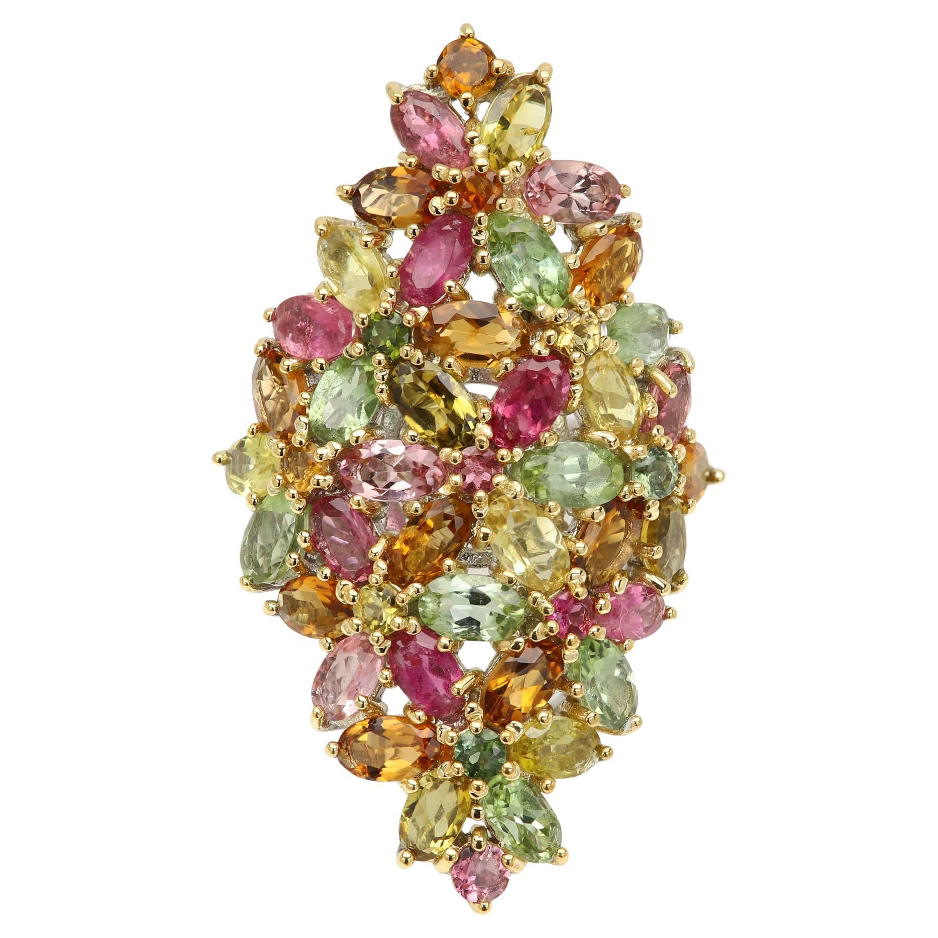 Vintage - as new 
Cluster Natural Tourmaline Gemstone
Rich Colors
Rich Colors AA approx 18 carat
Multi color mix
Sterling Silver approx 11.0 grams
(top plated with yellow gold)
Finger size 7 (can be re-sized)
Approx 38 oval tourmaline stones 6x4mm