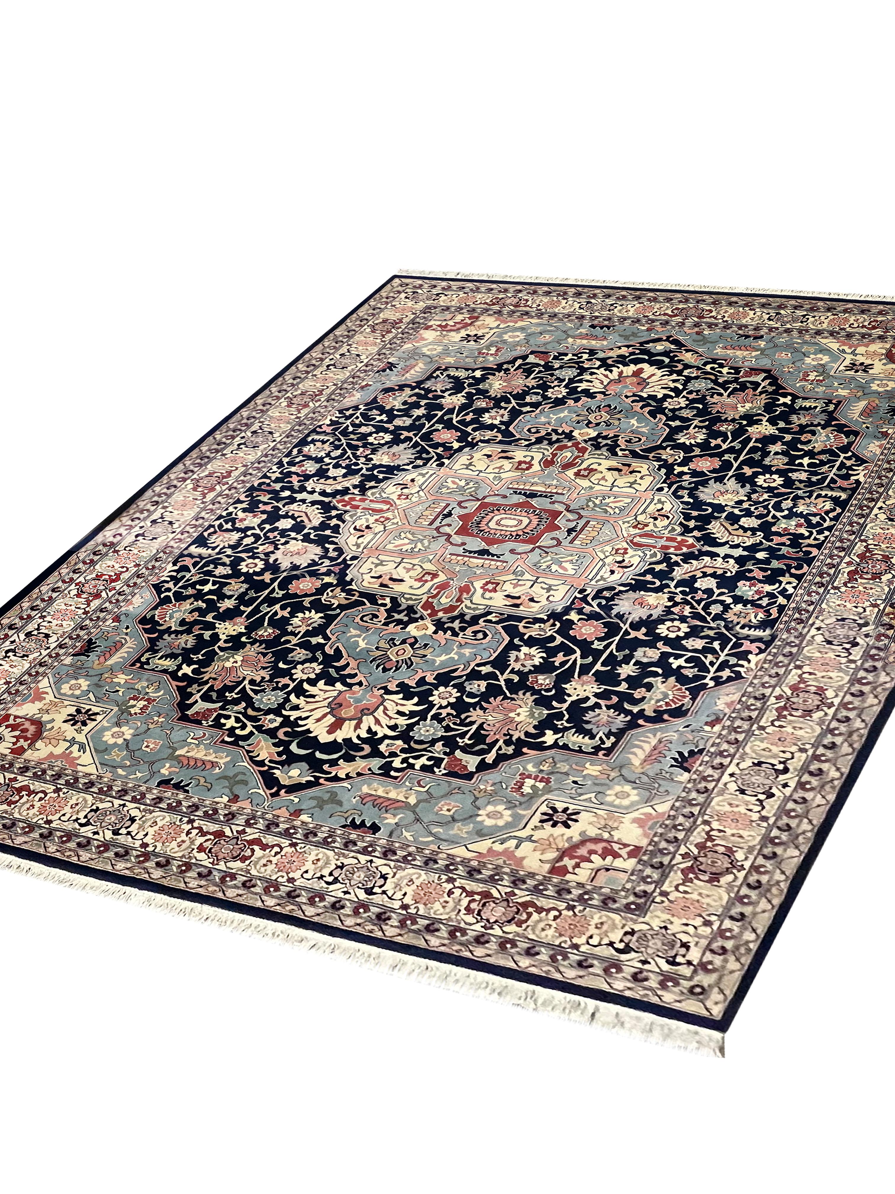 This bold wool area rug is a great example of a modern wool oriental rug. The design features a traditional Geometric design with a large central medallion woven in accents of beige, pink, red and blue that have been woven on a deep blue background.