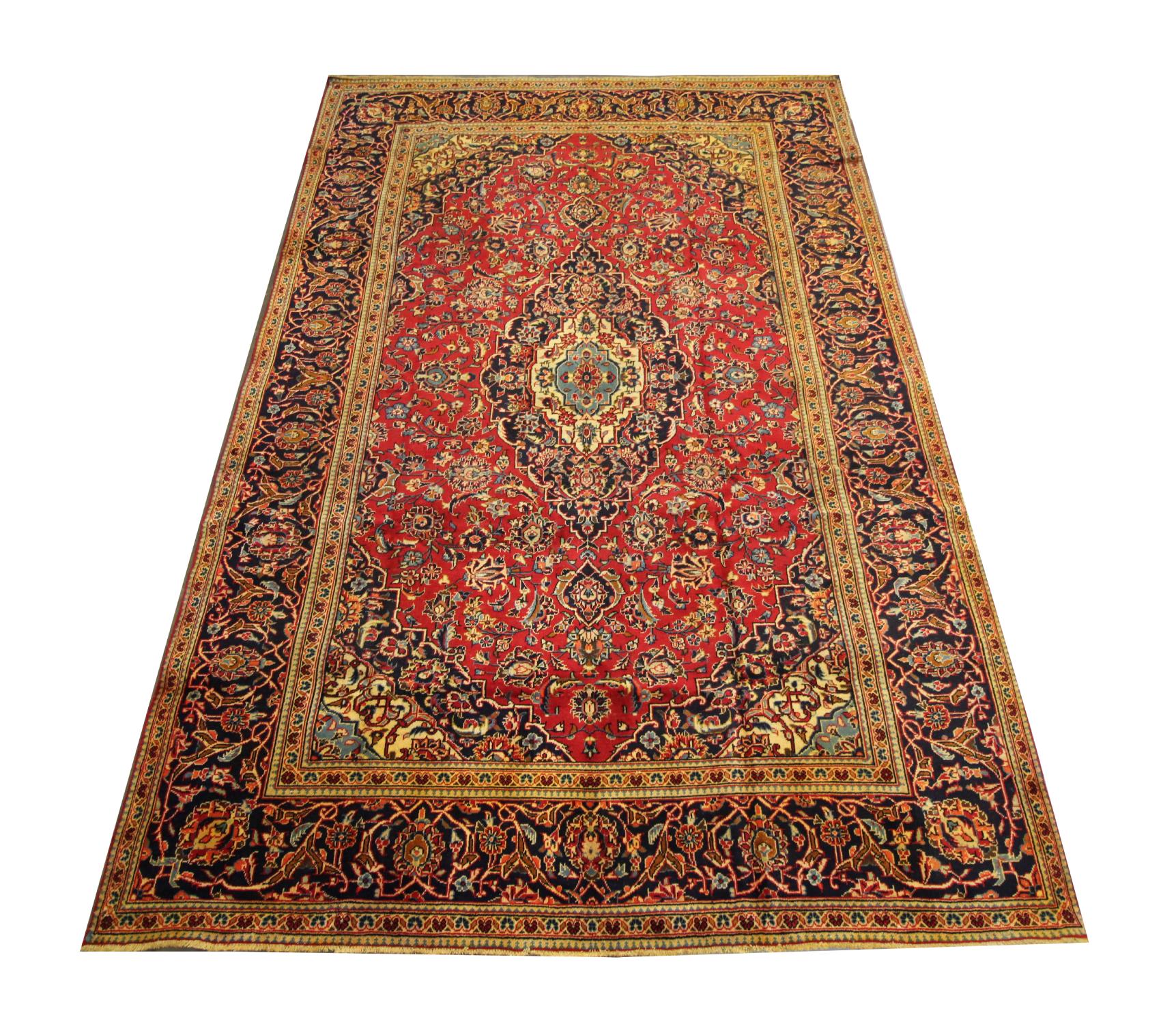 This large alluring carpet is a wonderful example of Turkish carpets woven in the late 20th century. The central design has been woven on a rich red field with deep blue, green, beige and rust accents that make up the decorative medallion and floral