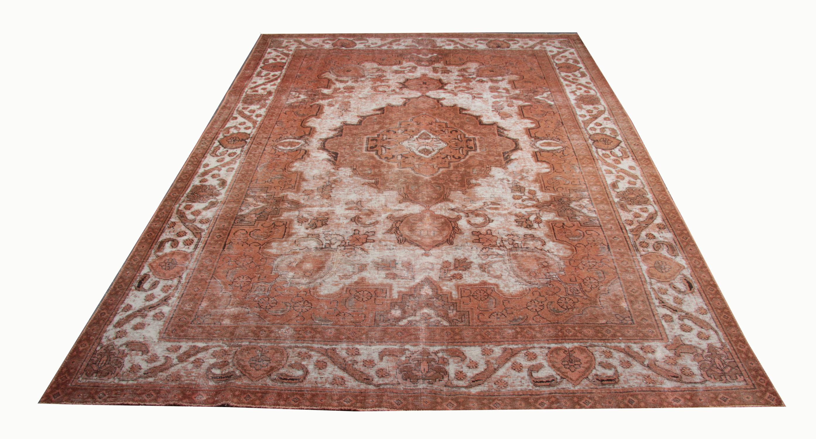This oriental wool area rug was woven by hand in the late 20th century and features an exquisite medallion design. Symmetrically woven with an intricate design featuring floral and geometric elements. The colours are simple with a traditional rust