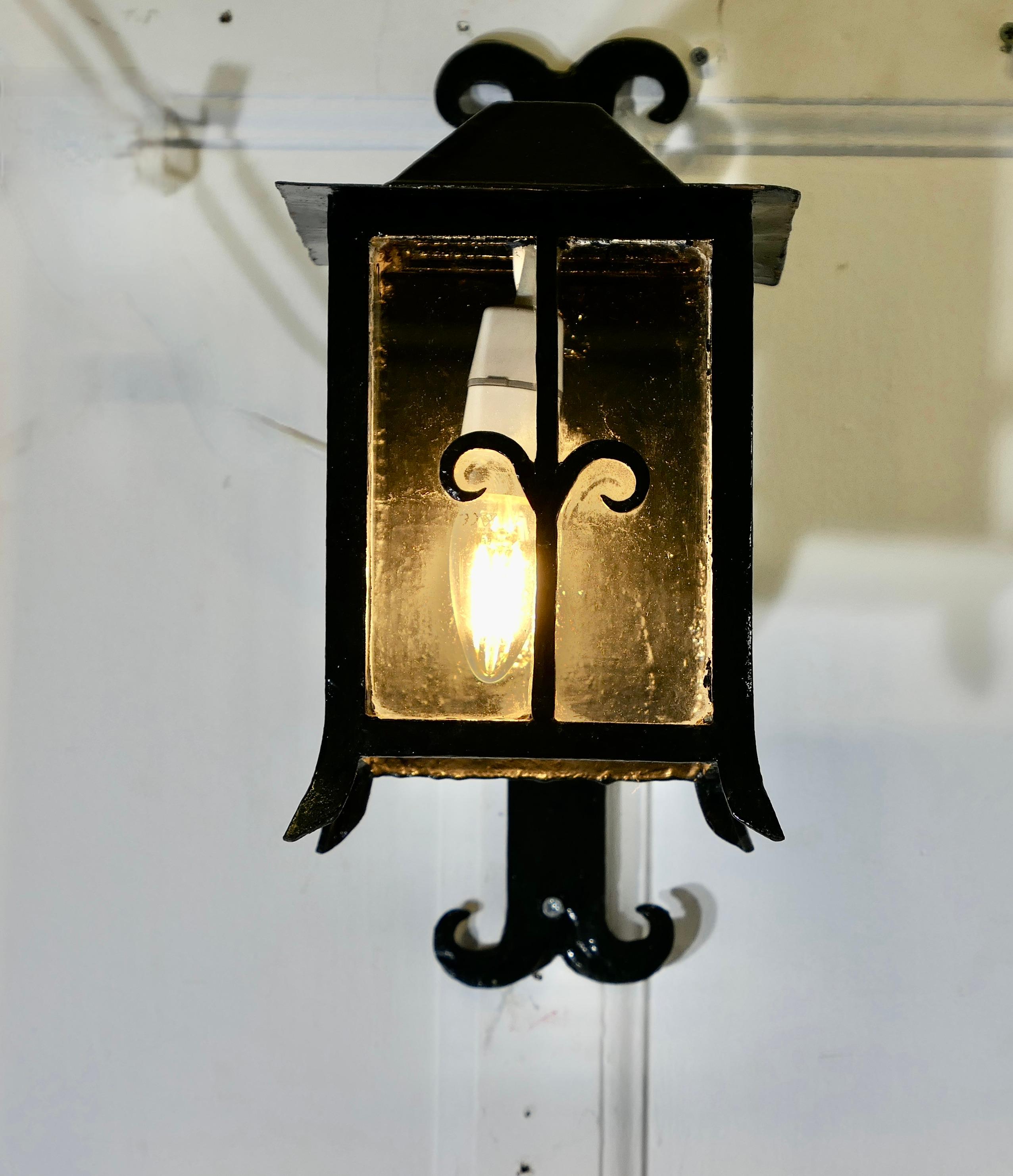 Large Traditional Wall Lantern

This is a Large Wall Lantern it has 3 glazed sides, it is hung out from the wall on a wrought iron bracket 
The lamp is wired for electricity and ready to  hang it will have to be connected to an electrical supply