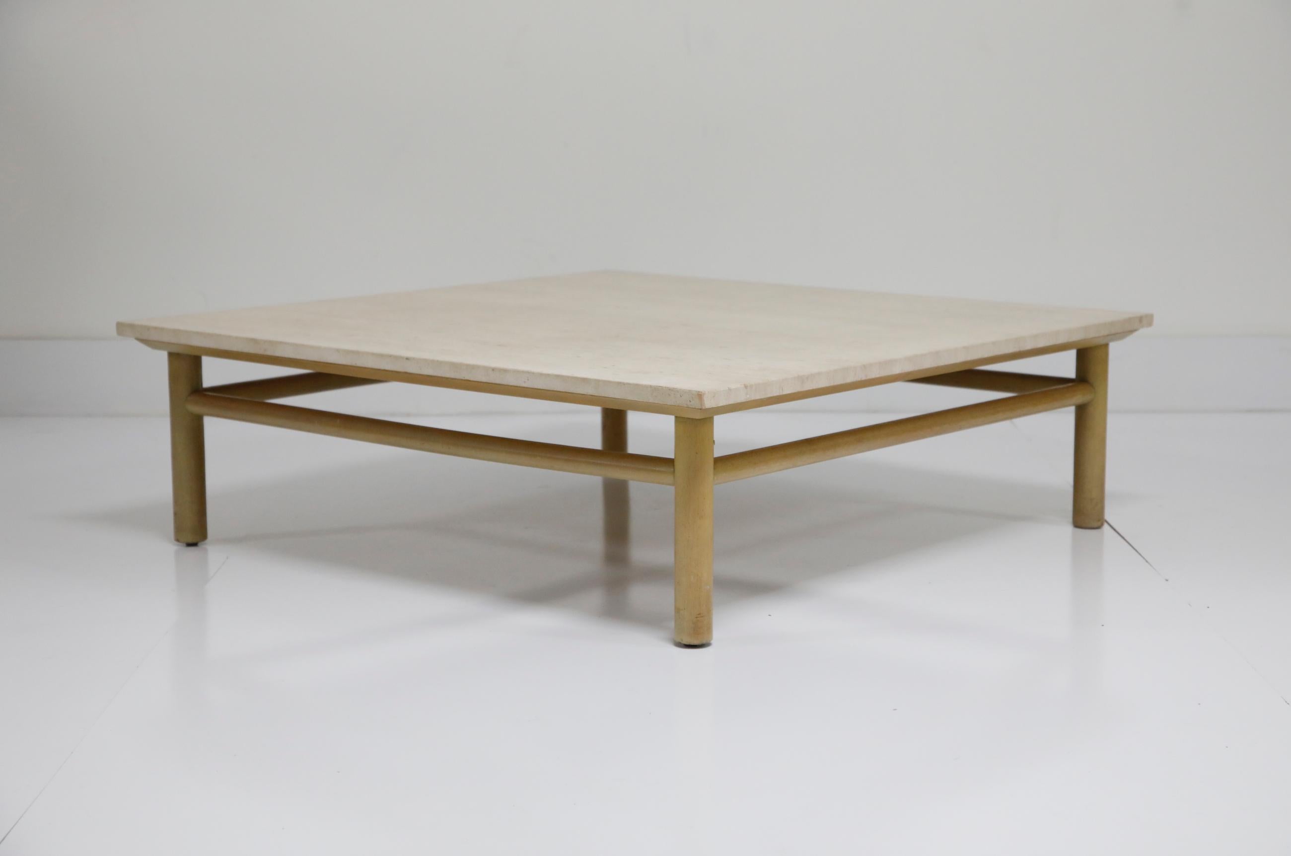 A beautiful, and large, travertine coffee table by T.H. Robsjohn Gibbings for Widdicomb of Grand Rapids. This incredible table is signed on the table base with a Widdicomb placard, and has its original travertine top which is in very good condition.