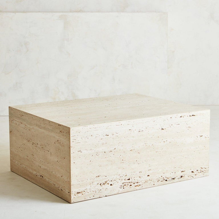 A monumental square 1970s travertine cube coffee table. This table is constructed with five slabs of unfilled travertine, which means is has some porous movement that is natural and inherent to this type of stone. This table brings an organic