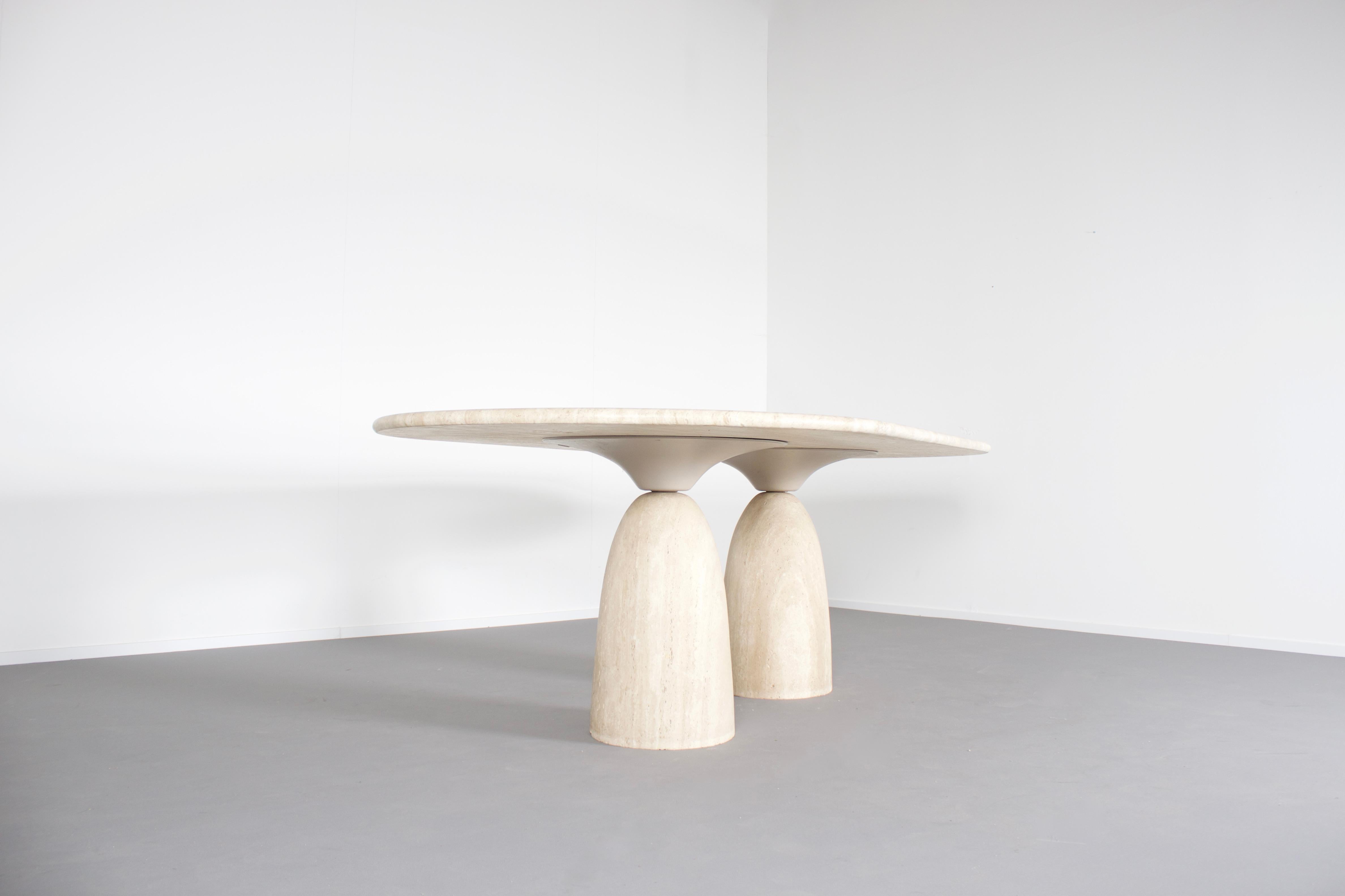 Impressive travertine ‘Finale 1790’ dining table in very good condition.

Designed by Peter Draenert in the 1970s. 

The table has two beautiful organic shaped pedestals.

The bottom section of the bases is made of solid travertine, the upper part