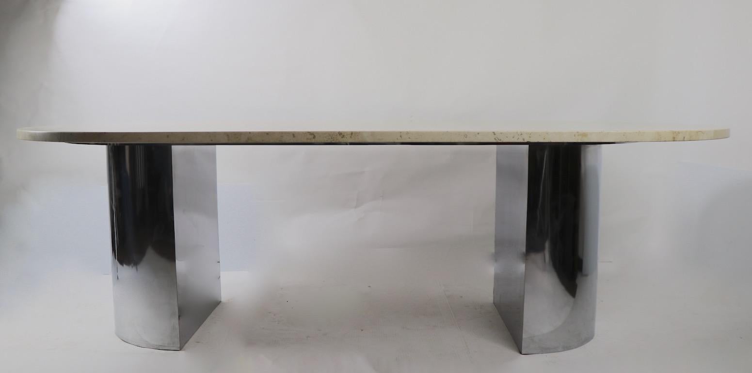 Impressive marble top table, suitable for use as a large dining, or small conference table. 1 inch thick marble oval slab top rests on opposing half round chrome bases. Probably Italian made, unsigned.