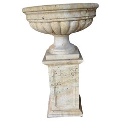 Large travertine planters on pedestals